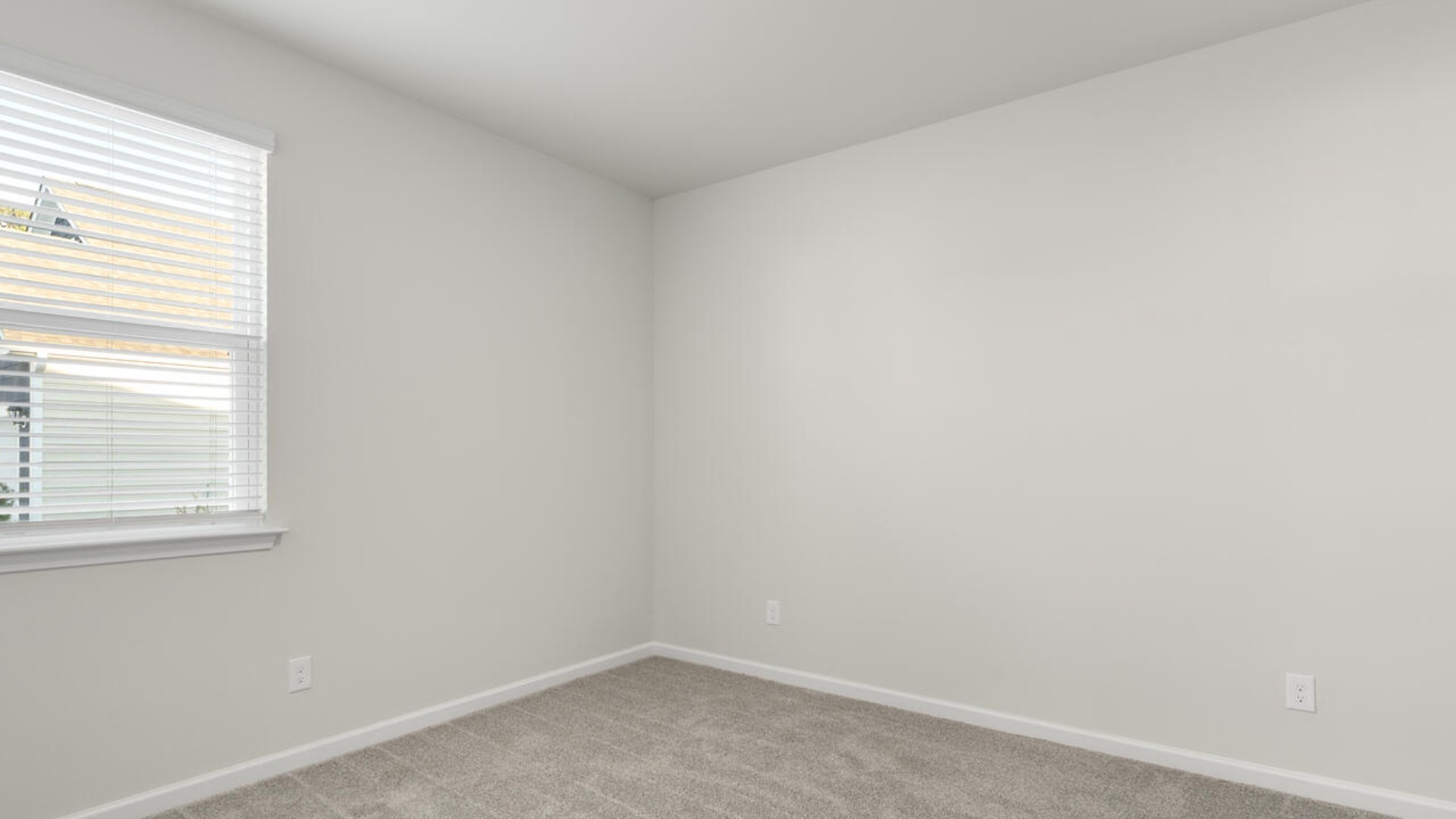 The split bedroom plan creates a private primary bedroom suite featuring two walk-in closets and a spacious en suite bath. There are three bedrooms at the front of the home with a full bathroom as well as laundry room.