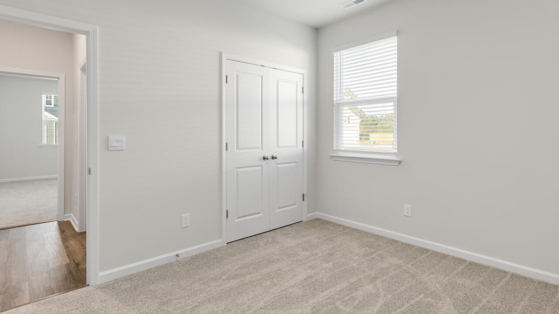 The split bedroom plan creates a private primary bedroom suite featuring two walk-in closets and a spacious en suite bath. There are three bedrooms at the front of the home with a full bathroom as well as laundry room.