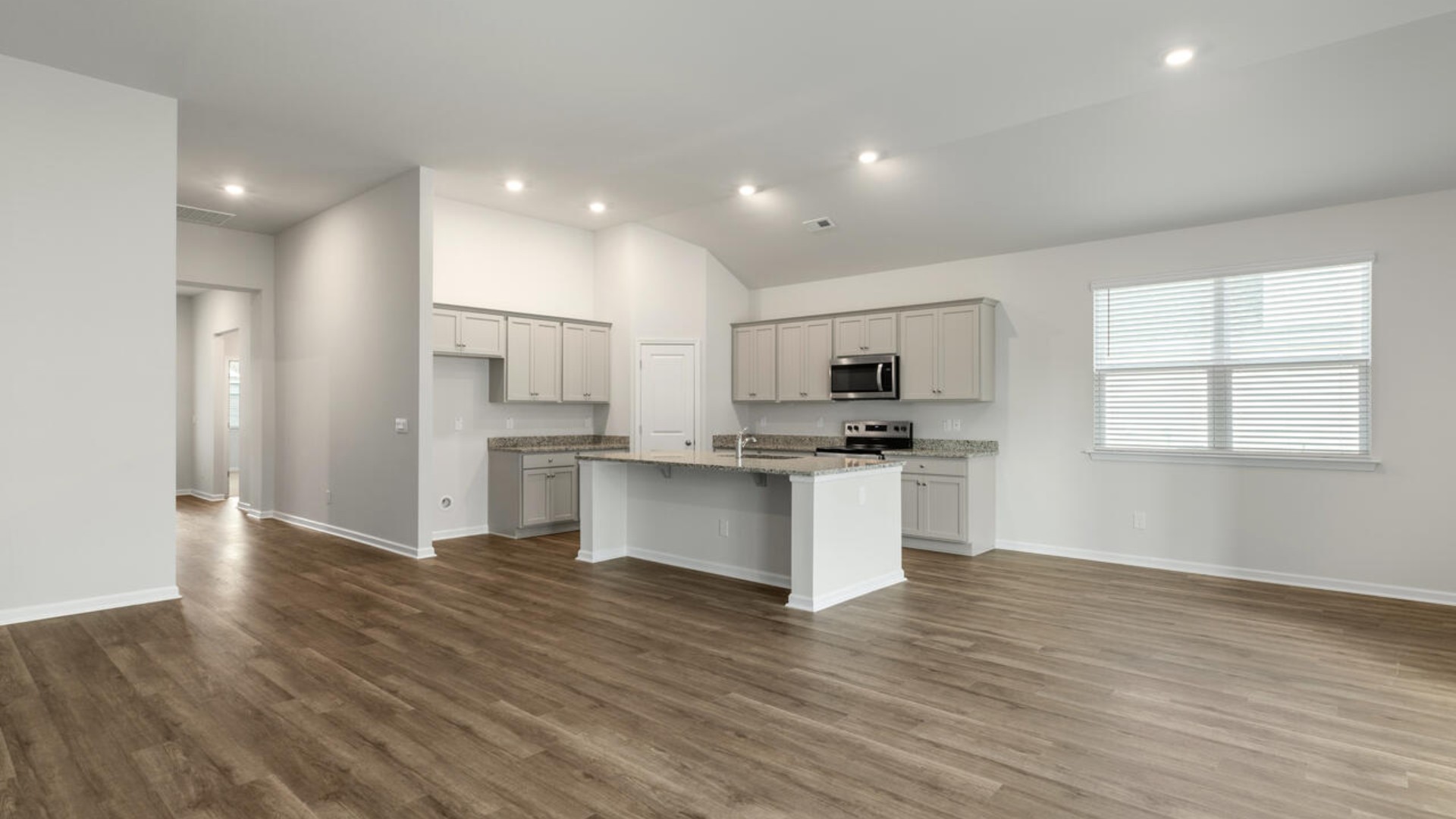 High ceilings and lots of windows create a bright and airy entertaining space. Open concept design with plenty of room for everyone to gather around the huge kitchen island.