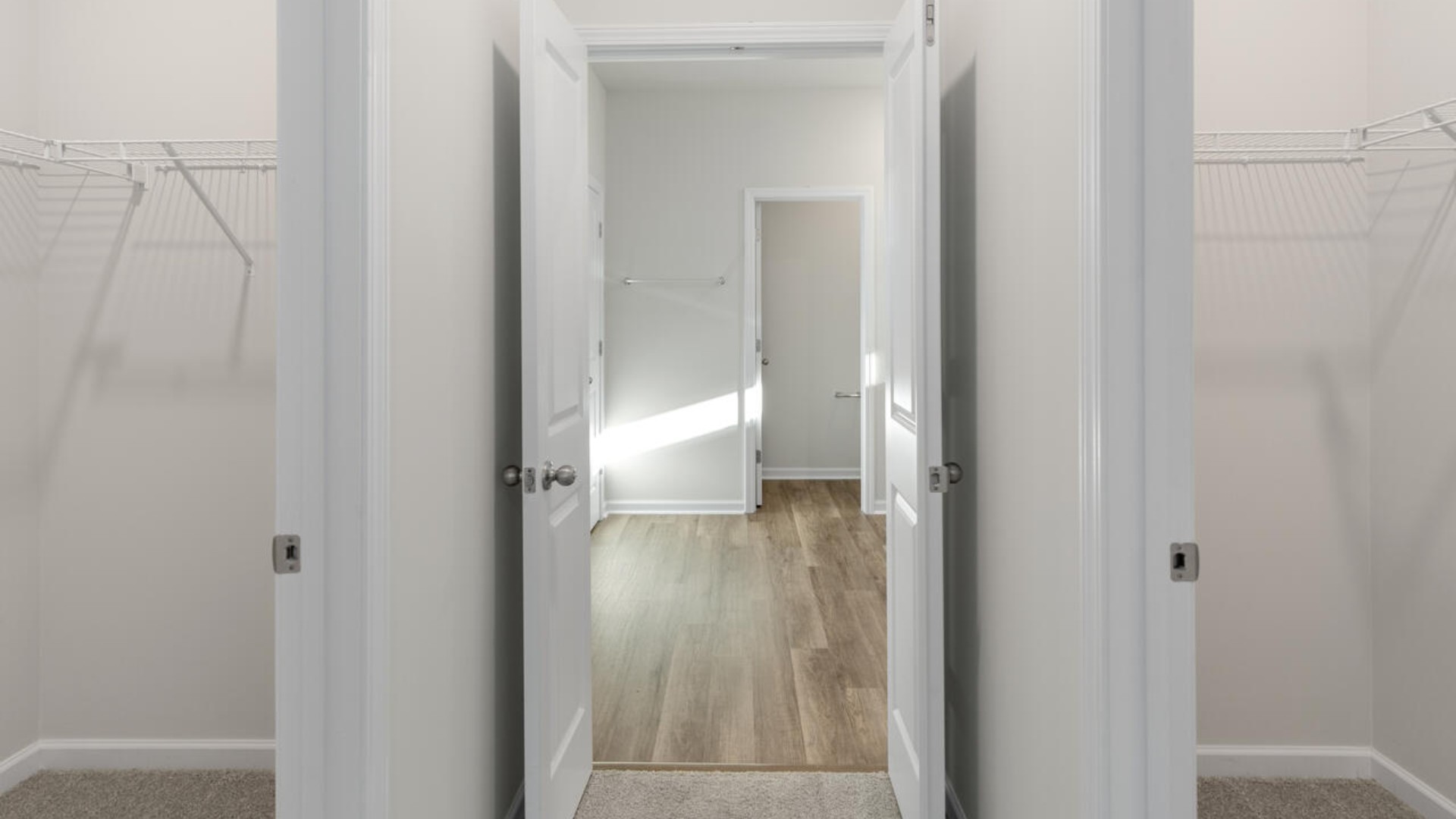 The split bedroom plan creates a private primary bedroom suite featuring two walk-in closets and a spacious en suite bath.