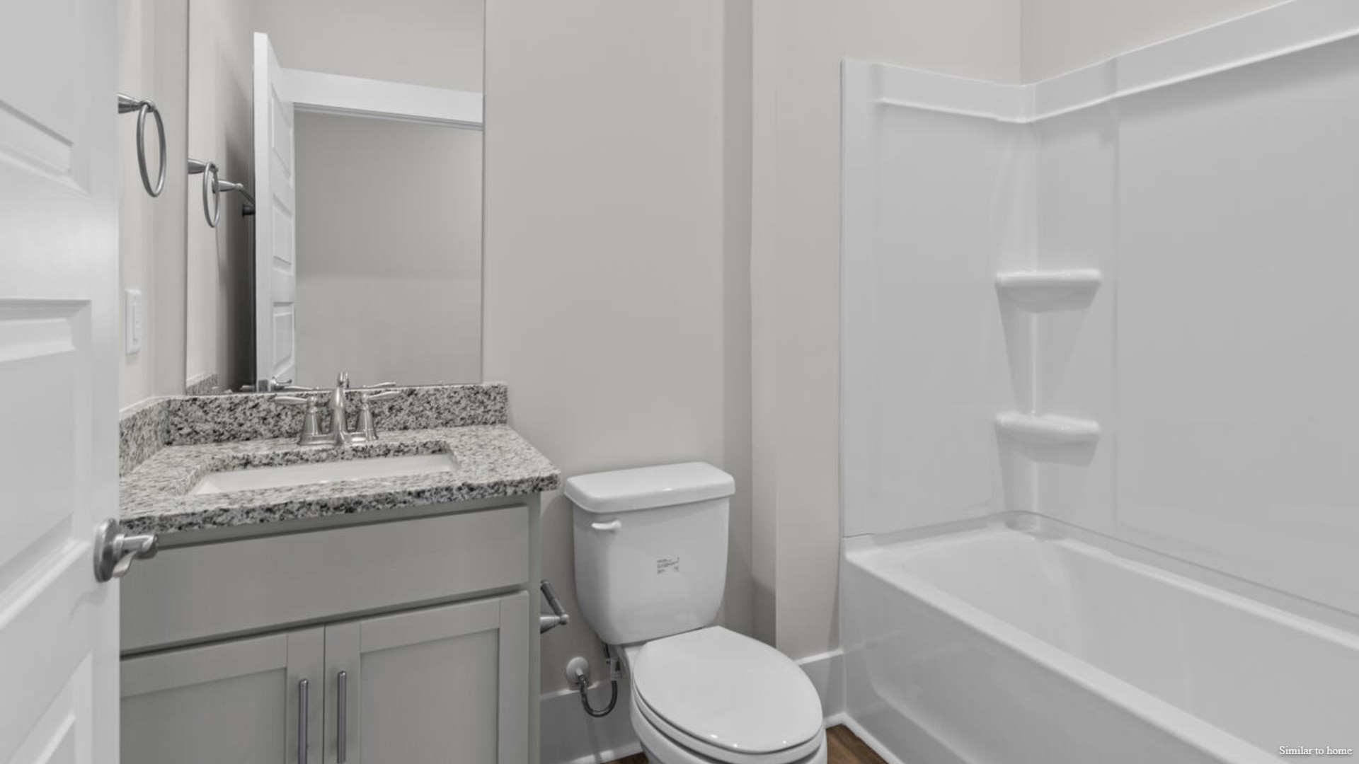 The primary suite bath features a step-in 5' shower and a dual vanity.