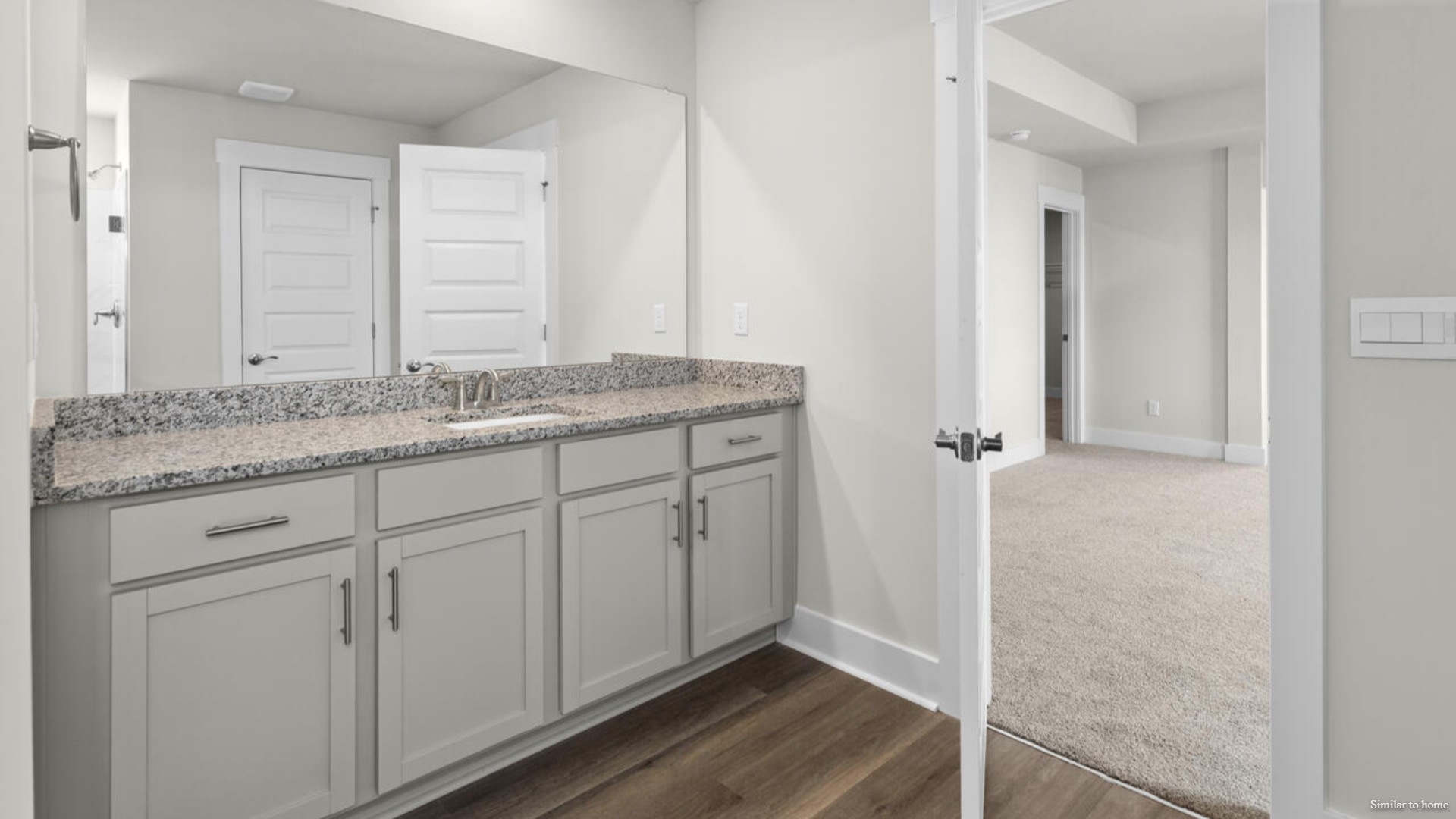 The primary suite bath features a step-in 5' shower and a dual vanity.