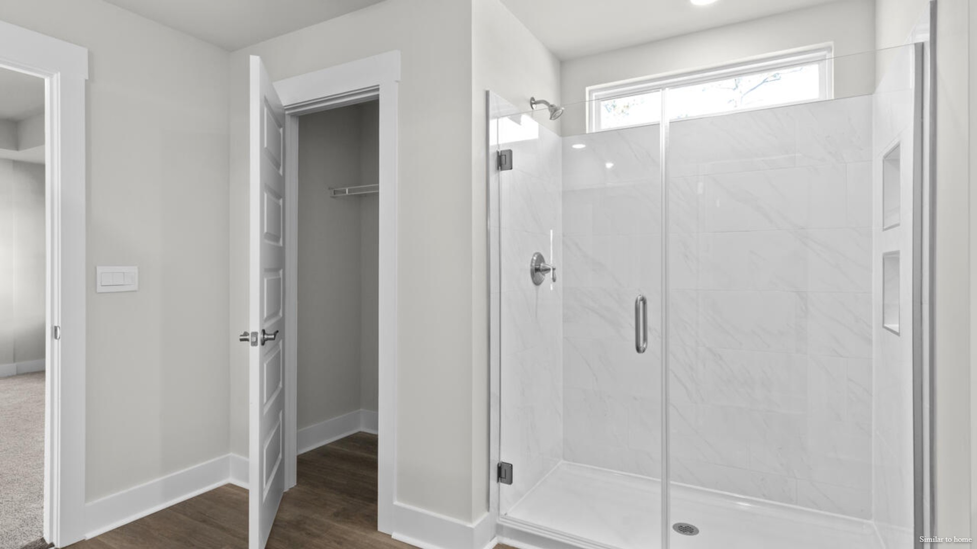 The primary suite bath features a step-in 5' shower and a dual vanity.