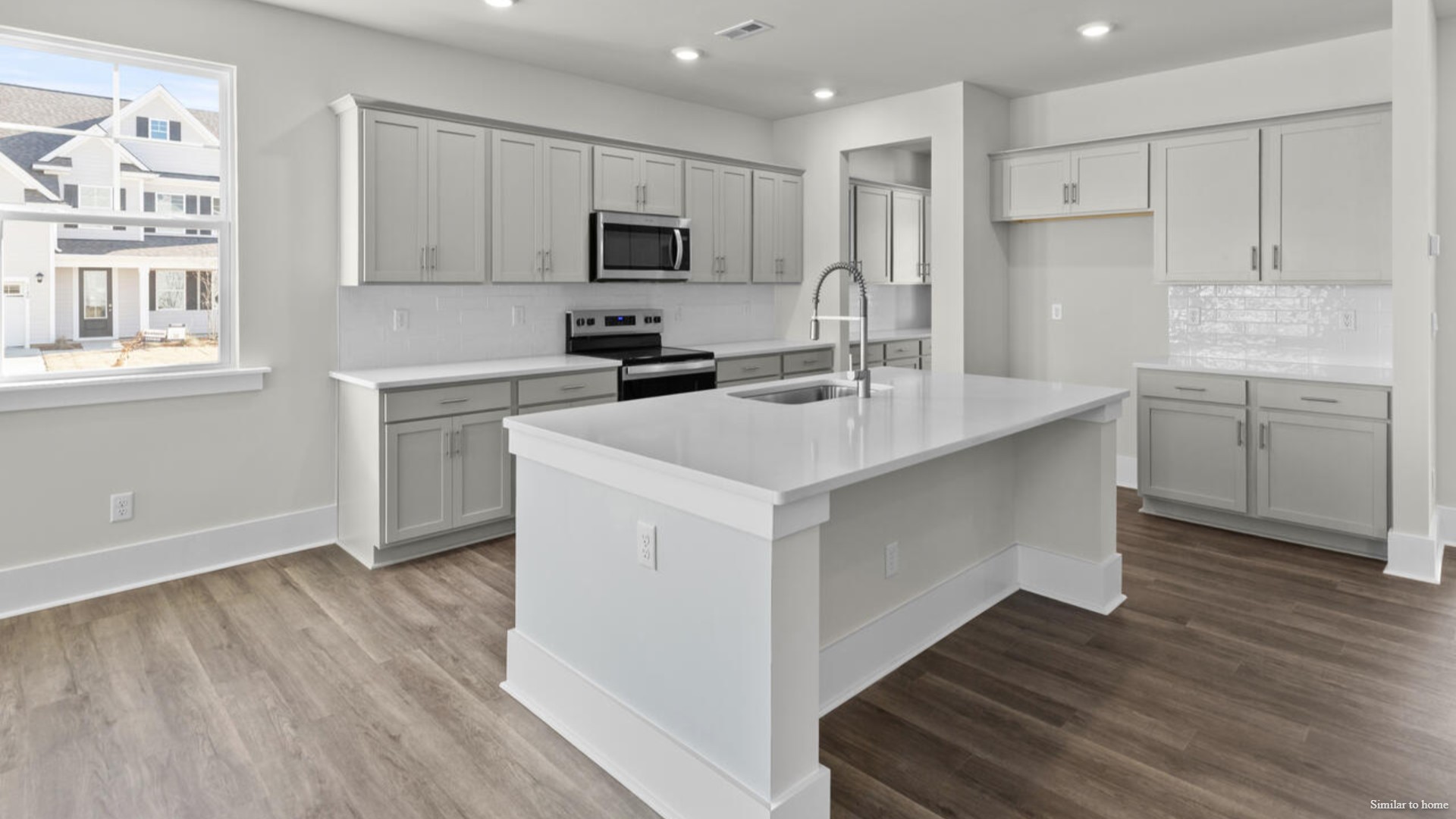 Downstairs there is a formal dining room that leads into a large butler's pantry then the kitchen. The kitchen is loaded with features including a granite island, 36'' cabinets, stainless-steel appliances and is open and expansive with a large island that overlooks the living room and the eat in kitchen area.