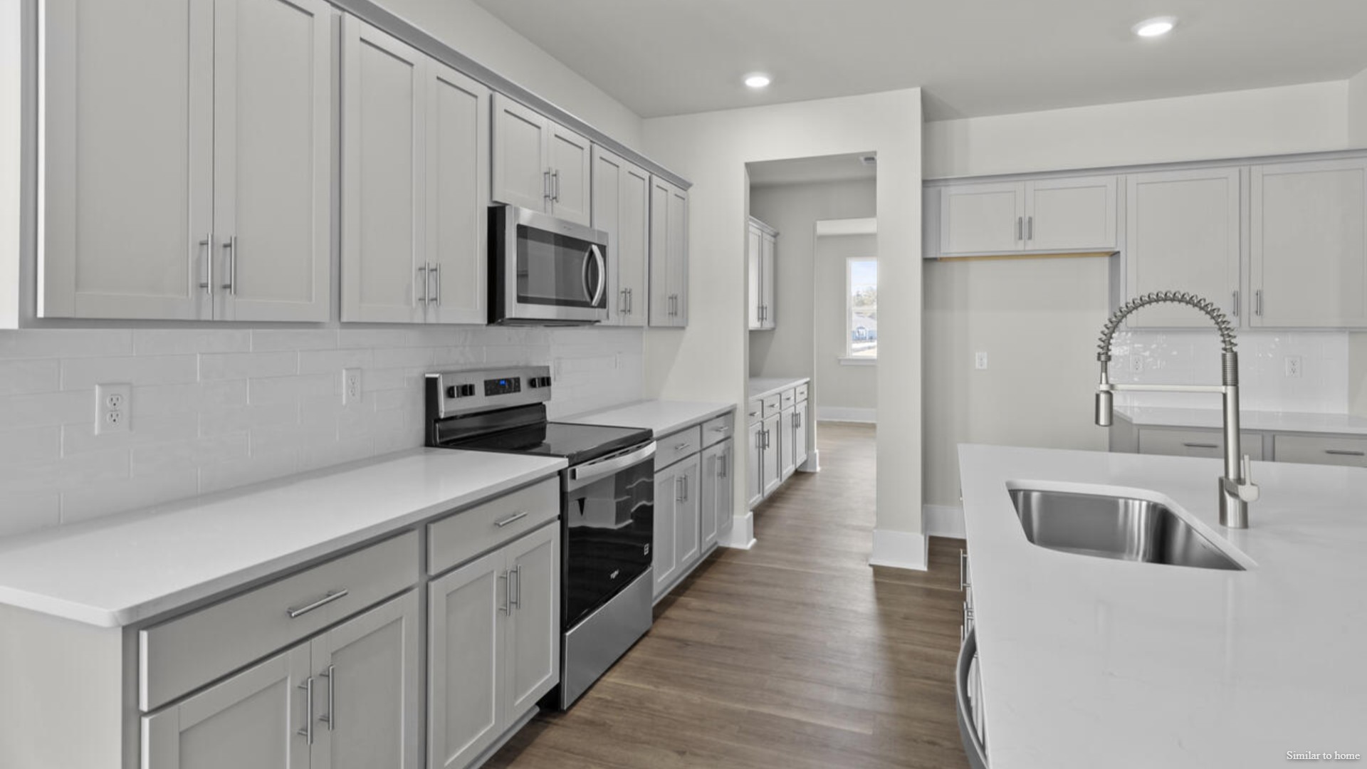 Downstairs there is a formal dining room that leads into a large butler's pantry then the kitchen. The kitchen is loaded with features including a granite island, 36'' cabinets, stainless-steel appliances and is open and expansive with a large island that overlooks the living room and the eat in kitchen area.
