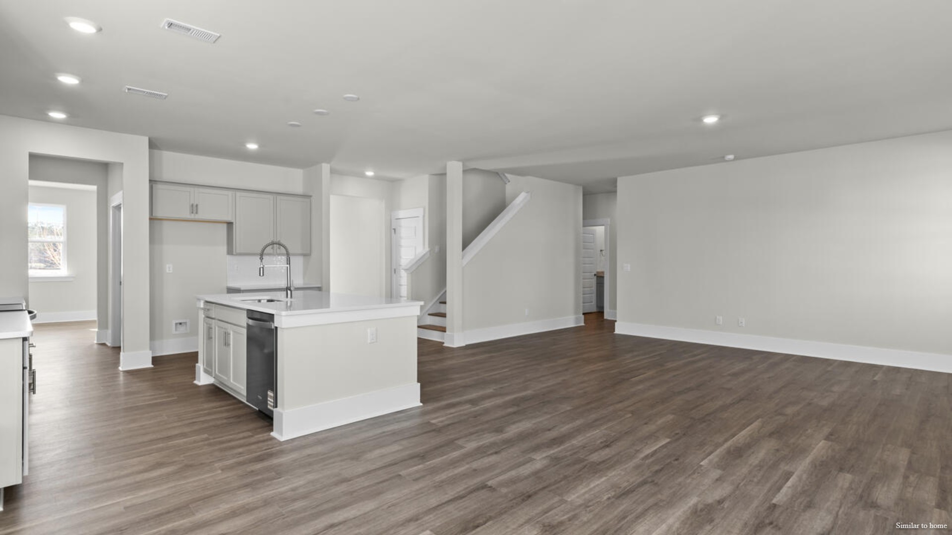 The kitchen is loaded with features including a granite island, 36'' cabinets, stainless-steel appliances and is open and expansive with a large island that overlooks the living room and the eat in kitchen area.