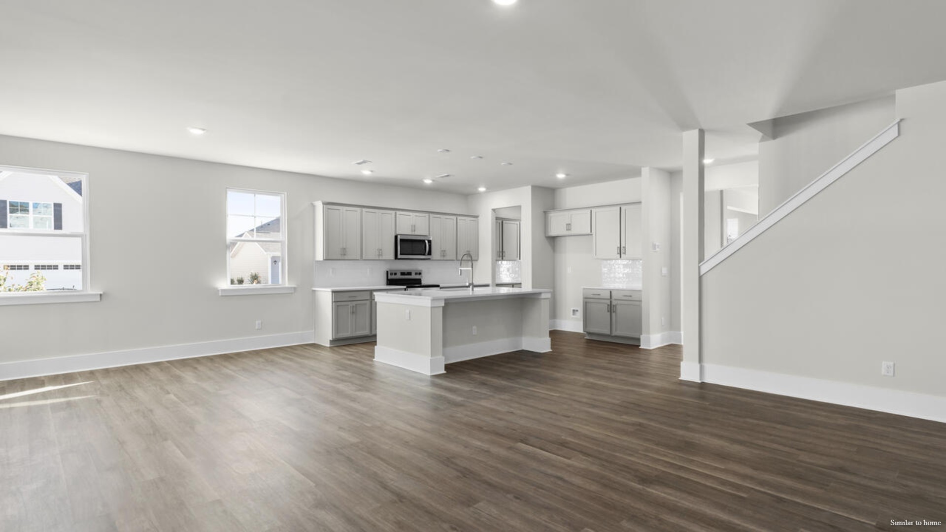 The kitchen is loaded with features including a granite island, 36'' cabinets, stainless-steel appliances and is open and expansive with a large island that overlooks the living room and the eat in kitchen area.