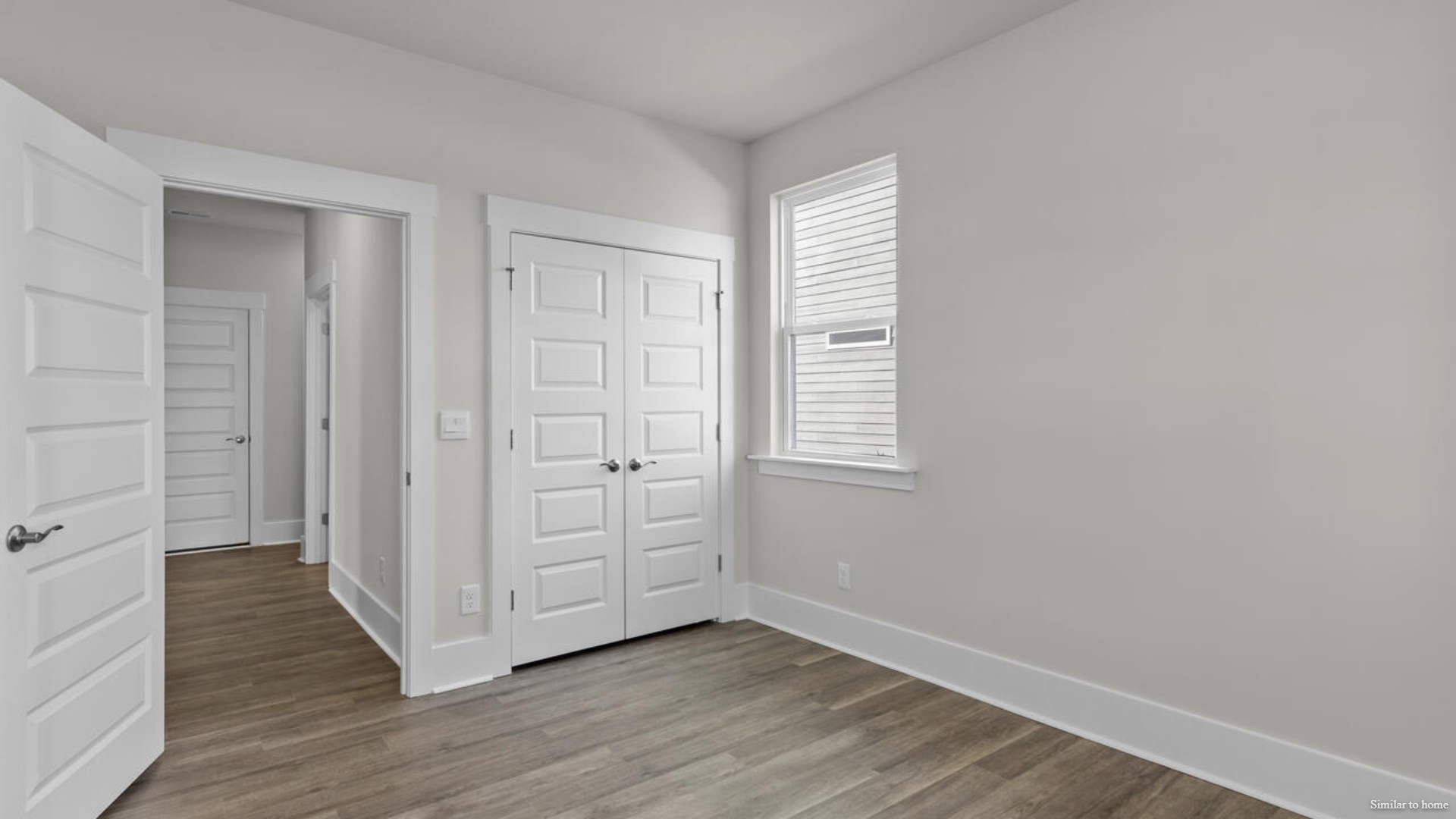 The primary suite bath features a step-in 5' shower and a dual vanity.