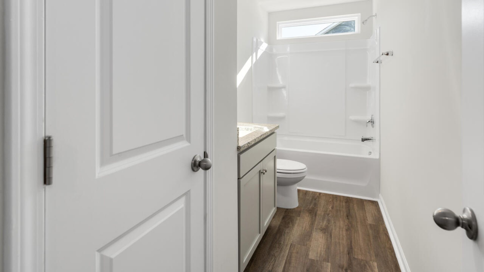 The Tillman floorplan features a first-floor primary suite, formal dining room, a large open living space divided by a kitchen island, and powder room on the first floor. Upstairs you are greeted by an convenient lof