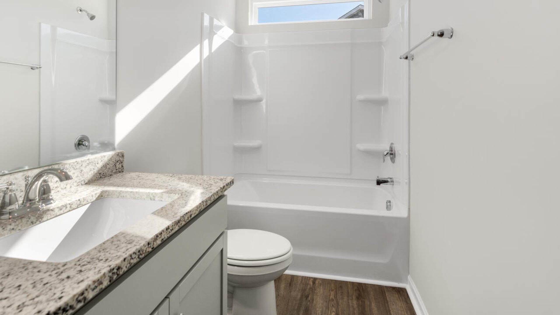 The Tillman floorplan features a first-floor primary suite, formal dining room, a large open living space divided by a kitchen island, and powder room on the first floor. Upstairs you are greeted by an convenient lof