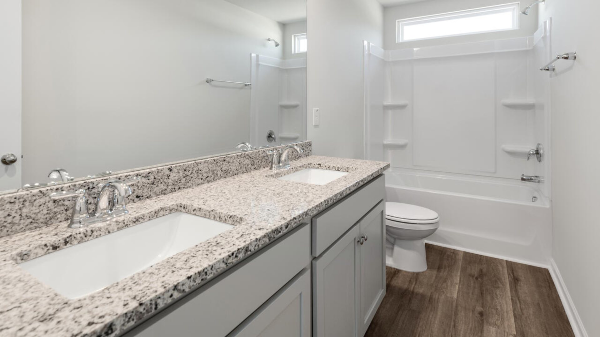 The Tillman floorplan features a first-floor primary suite, formal dining room, a large open living space divided by a kitchen island, and powder room on the first floor. Upstairs you are greeted by an convenient lof