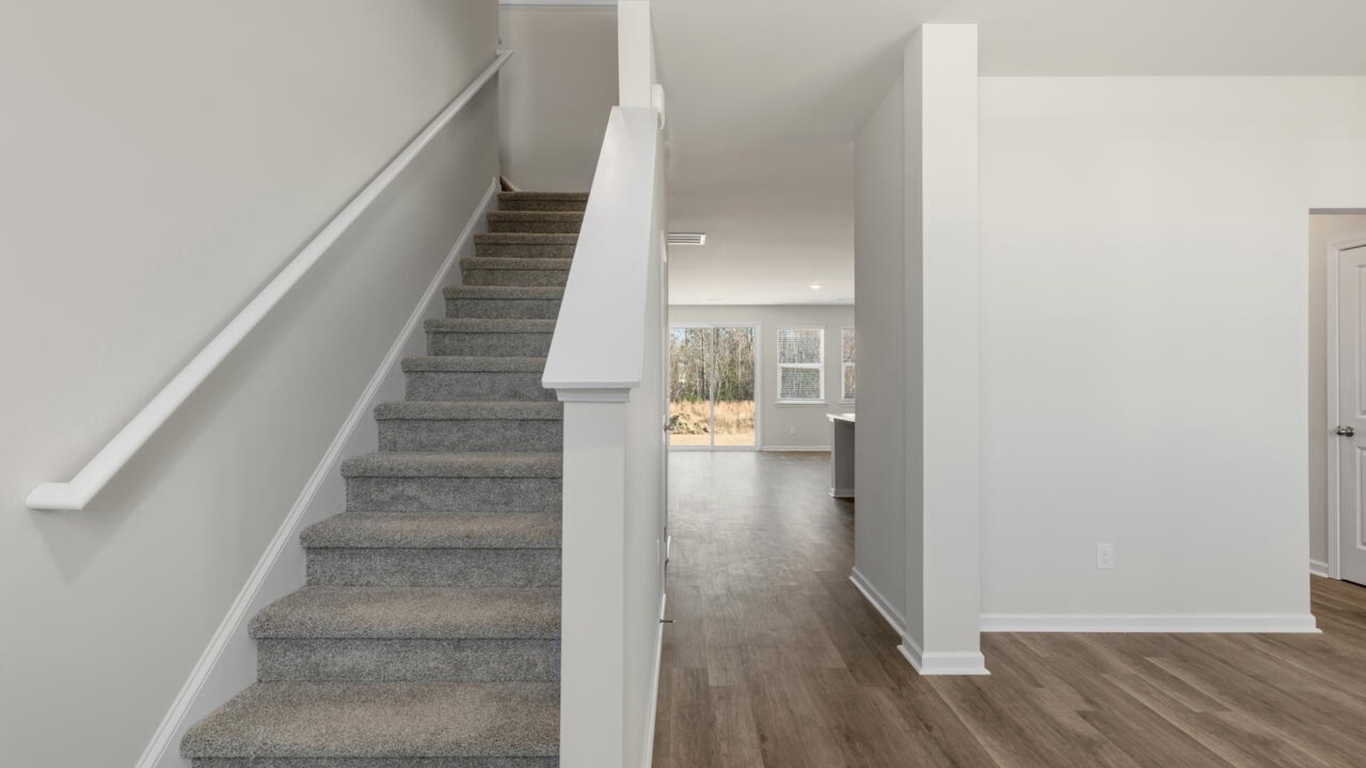 The Tillman floorplan features a first-floor primary suite, formal dining room, a large open living space divided by a kitchen island, and powder room on the first floor. Upstairs you are greeted by an convenient lof