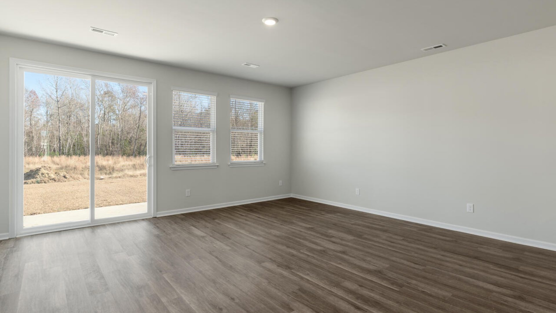 Our Tillman plan is a spacious home with a formal dining room, open concept kitchen with granite countertops, stainless steel appliances and family room with additional seating at the large kitchen island, and a first floor primary bedroom retreat.