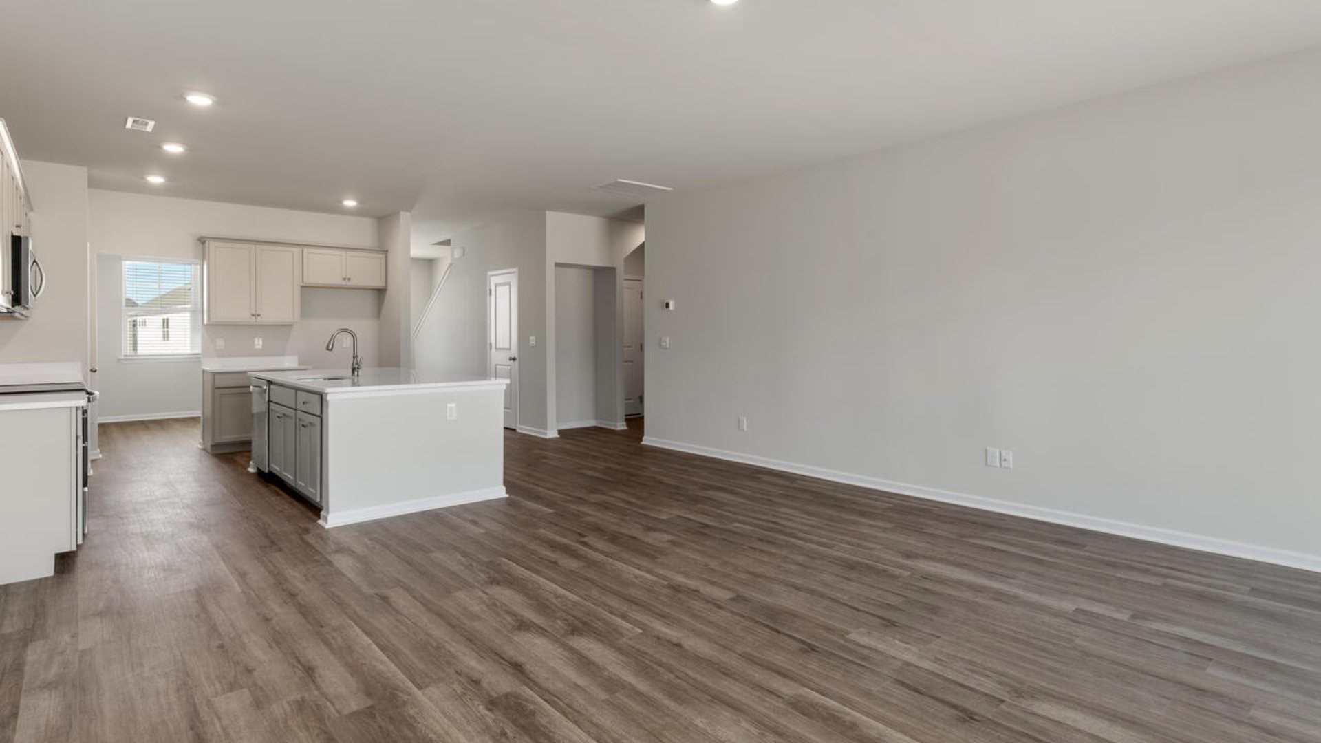 Our Tillman plan is a spacious home with a formal dining room, open concept kitchen with granite countertops, stainless steel appliances and family room with additional seating at the large kitchen island, and a first floor primary bedroom retreat.