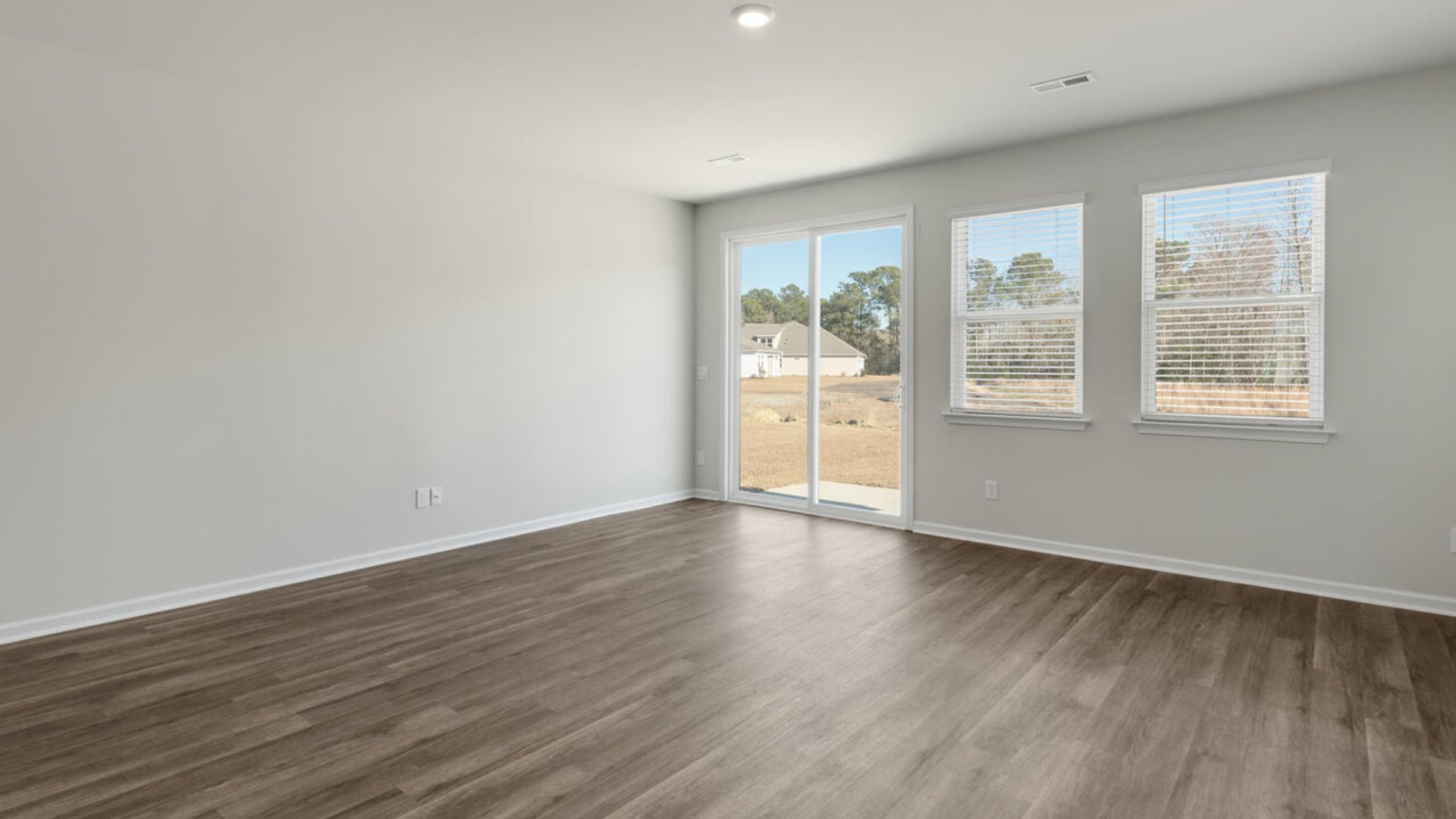 Our Tillman plan is a spacious home with a formal dining room, open concept kitchen with granite countertops, stainless steel appliances and family room with additional seating at the large kitchen island, and a first floor primary bedroom retreat.