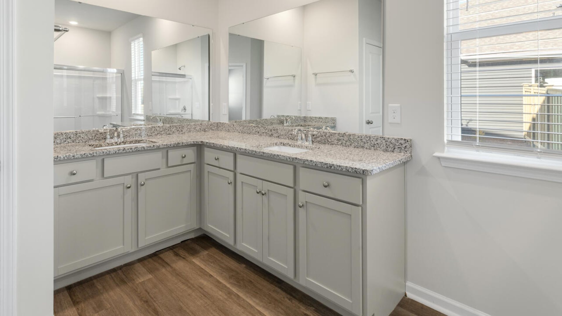 The Tillman floorplan features a first-floor primary suite, formal dining room, a large open living space divided by a kitchen island, and powder room on the first floor. Upstairs you are greeted by an convenient lof