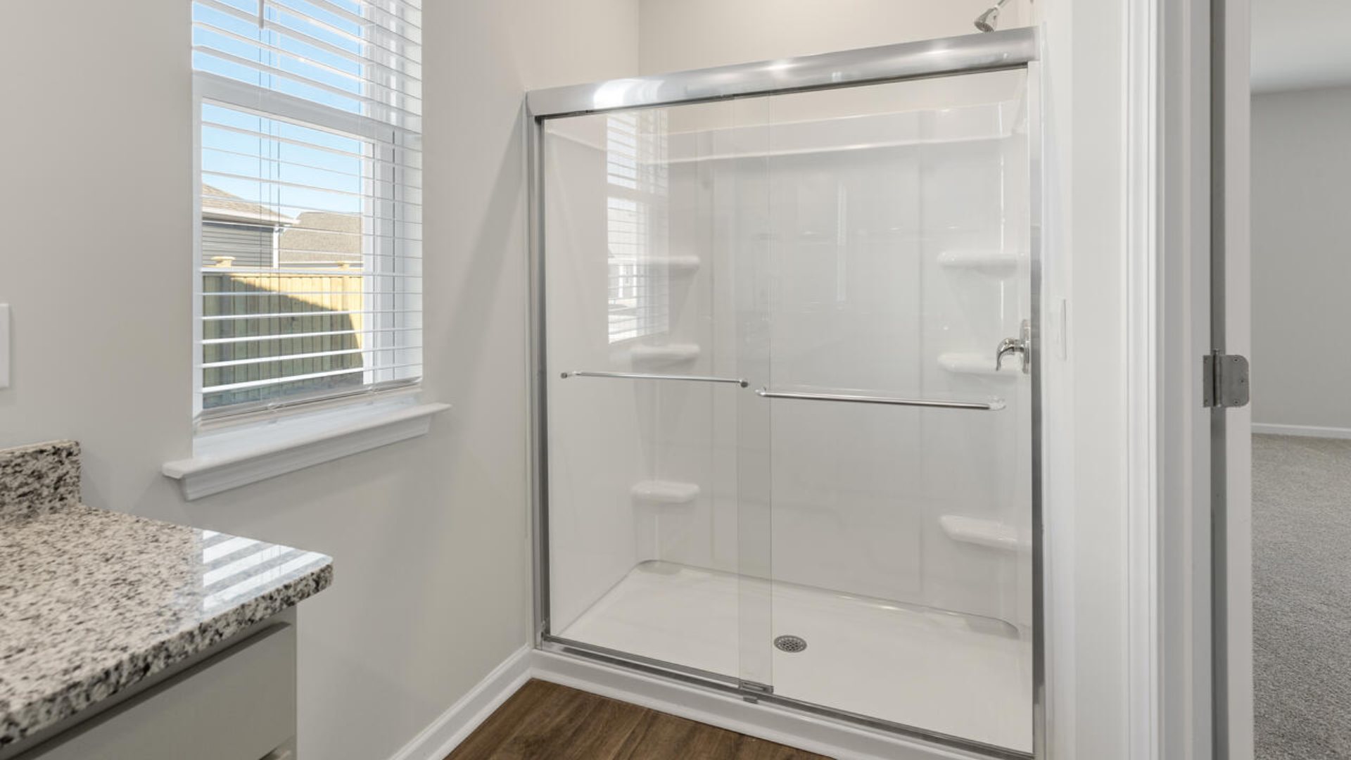 The Tillman floorplan features a first-floor primary suite, formal dining room, a large open living space divided by a kitchen island, and powder room on the first floor. Upstairs you are greeted by an convenient lof