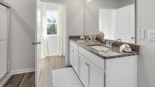 The primary suite on the second level offers a luxurious Primary bath with a soaking garden tub and separate shower, private bathroom, double vanities and a large walk-in clo