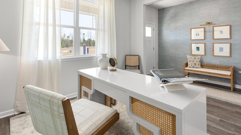 The main level features a flex room adjacent to the foyer, ideal for a formal dining room or home office. The gourmet kitchen has an oversized island for extra seating and a large pantry, and it opens to the dining area and a spacious living room. A bedroom with a full bathroom completes the main level.
