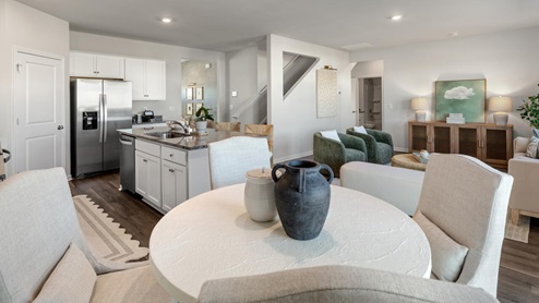 The main level features a flex room adjacent to the foyer, ideal for a formal dining room or home office. The gourmet kitchen has an oversized island for extra seating and a large pantry, and it opens to the dining area and a spacious living room. A bedroom with a full bathroom completes the main level.
