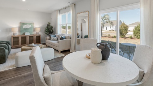 The main level features a flex room adjacent to the foyer, ideal for a formal dining room or home office. The gourmet kitchen has an oversized island for extra seating and a large pantry, and it opens to the dining area and a spacious living room. A bedroom with a full bathroom completes the main level.