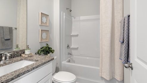 The primary suite on the second level offers a luxurious Primary bath with a soaking garden tub and separate shower, private bathroom, double vanities and a large walk-in clo