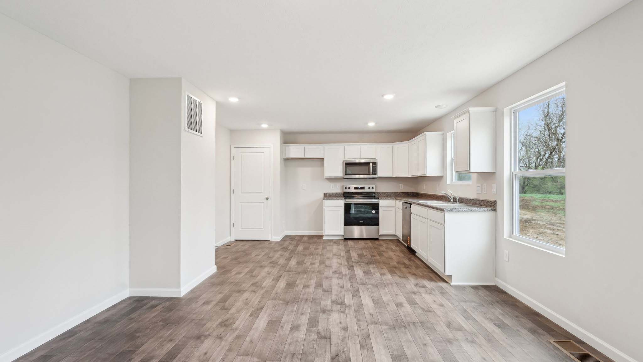 The living area is an open concept, where your kitchen, living, and dining areas blend seamlessly into a space perfect for everyday living and entertaining. There is a downstairs powder room.