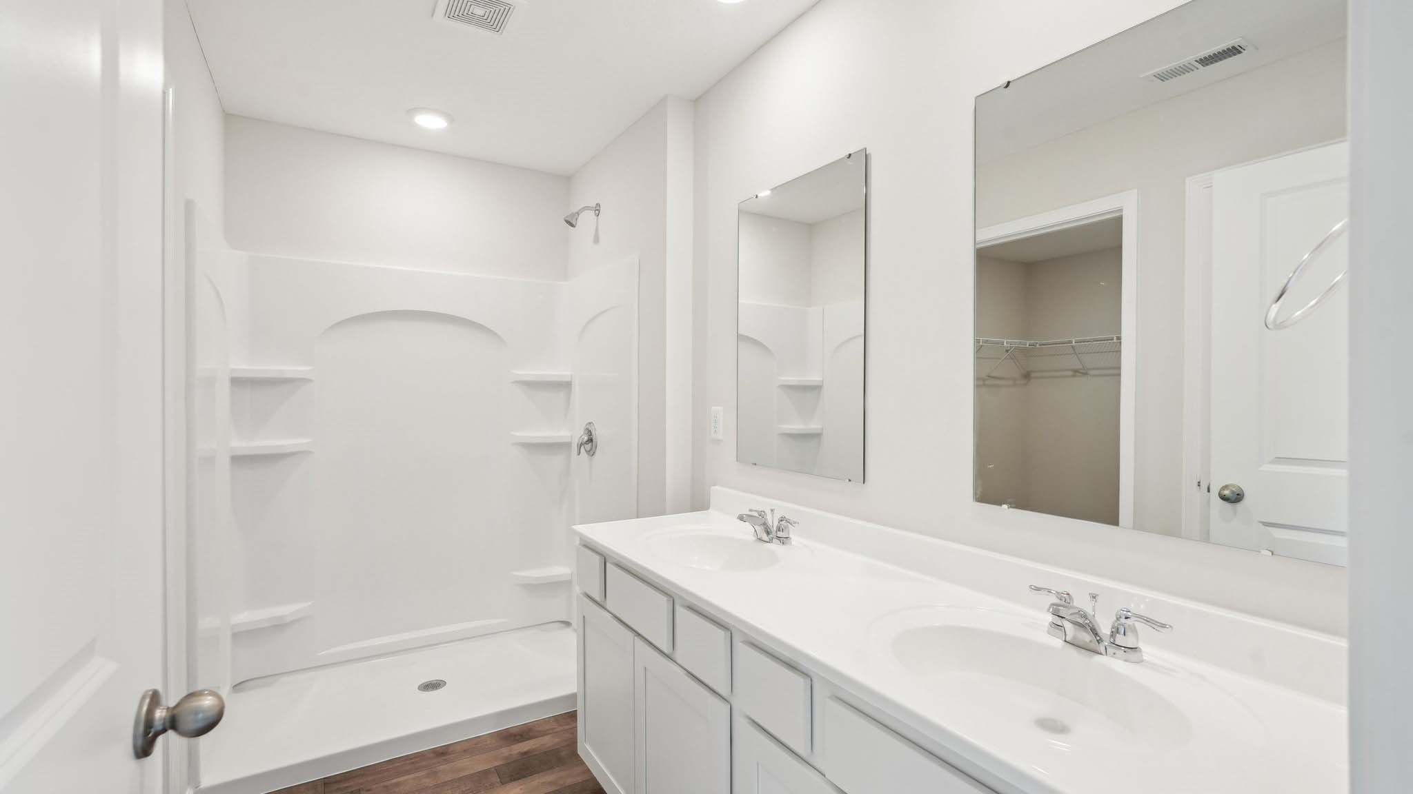 Upstairs is a loft that leads into the spacious primary bedroom. The primary bedroom features a walk-in-closet as well as a comfortable en-suite bathroom and sharing a sink isn’t a worry with the double vanity.