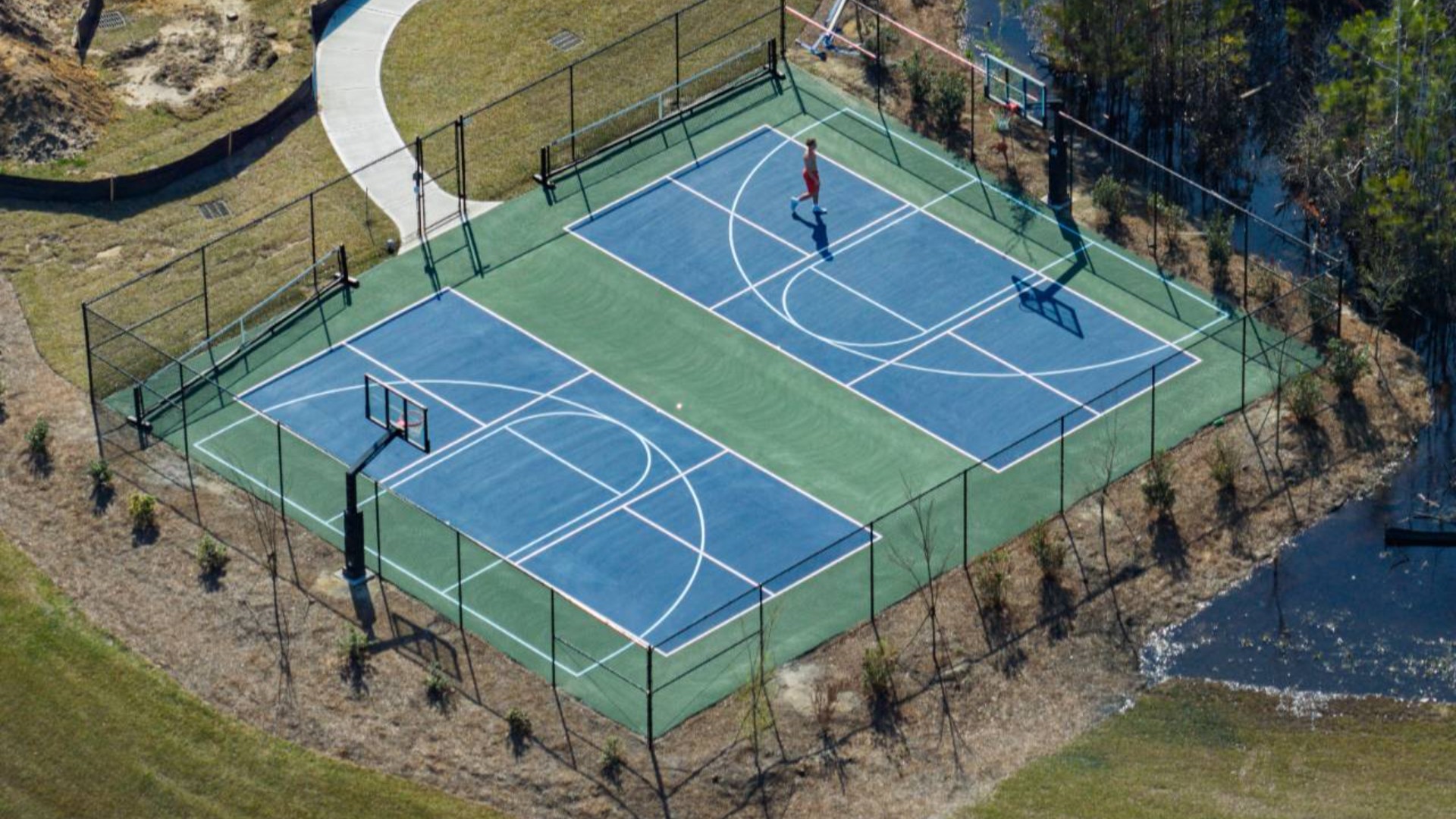 The amenity center that includes a swimming pool, multi-sport court, splashpad, playground, and fire pit, ensuring a well-rounded and enjoyable living experience.