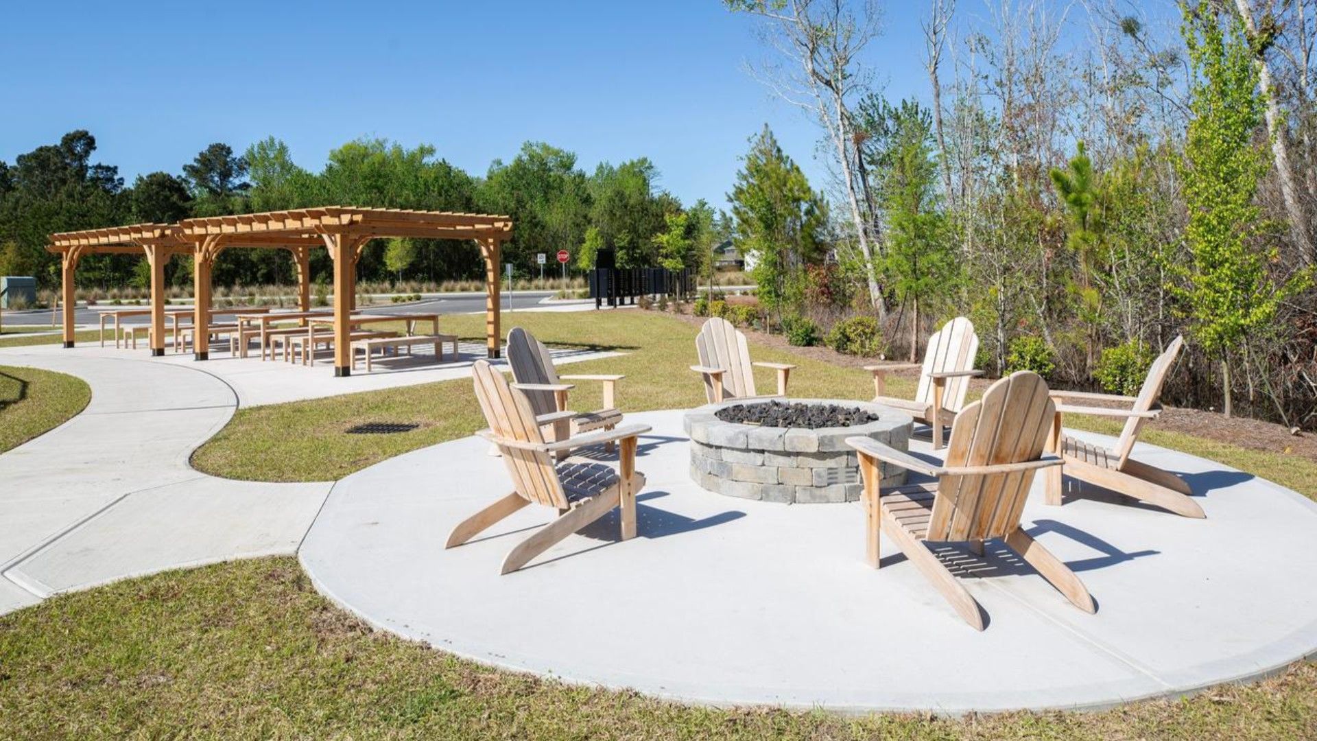 The amenity center that includes a swimming pool, multi-sport court, splashpad, playground, and fire pit, ensuring a well-rounded and enjoyable living experience.