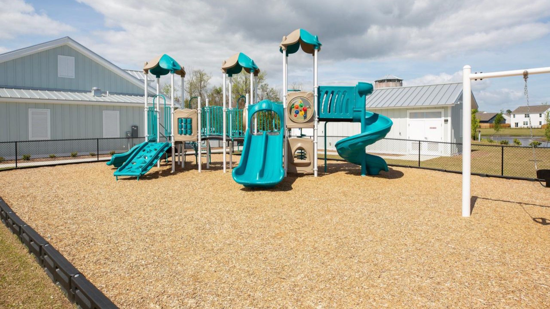 The amenity center that includes a swimming pool, multi-sport court, splashpad, playground, and fire pit, ensuring a well-rounded and enjoyable living experience.