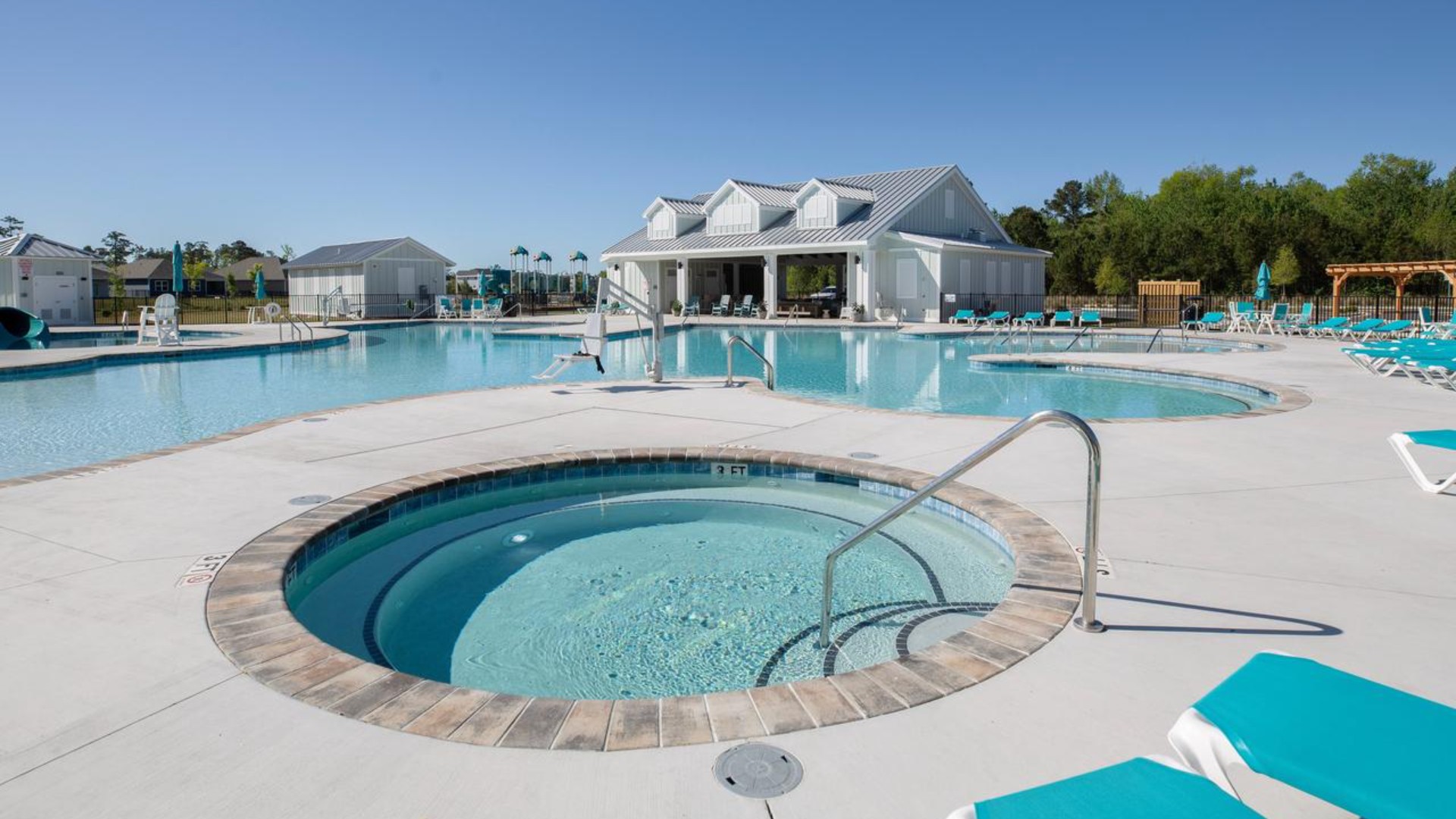 The amenity center that includes a swimming pool, multi-sport court, splashpad, playground, and fire pit, ensuring a well-rounded and enjoyable living experience.