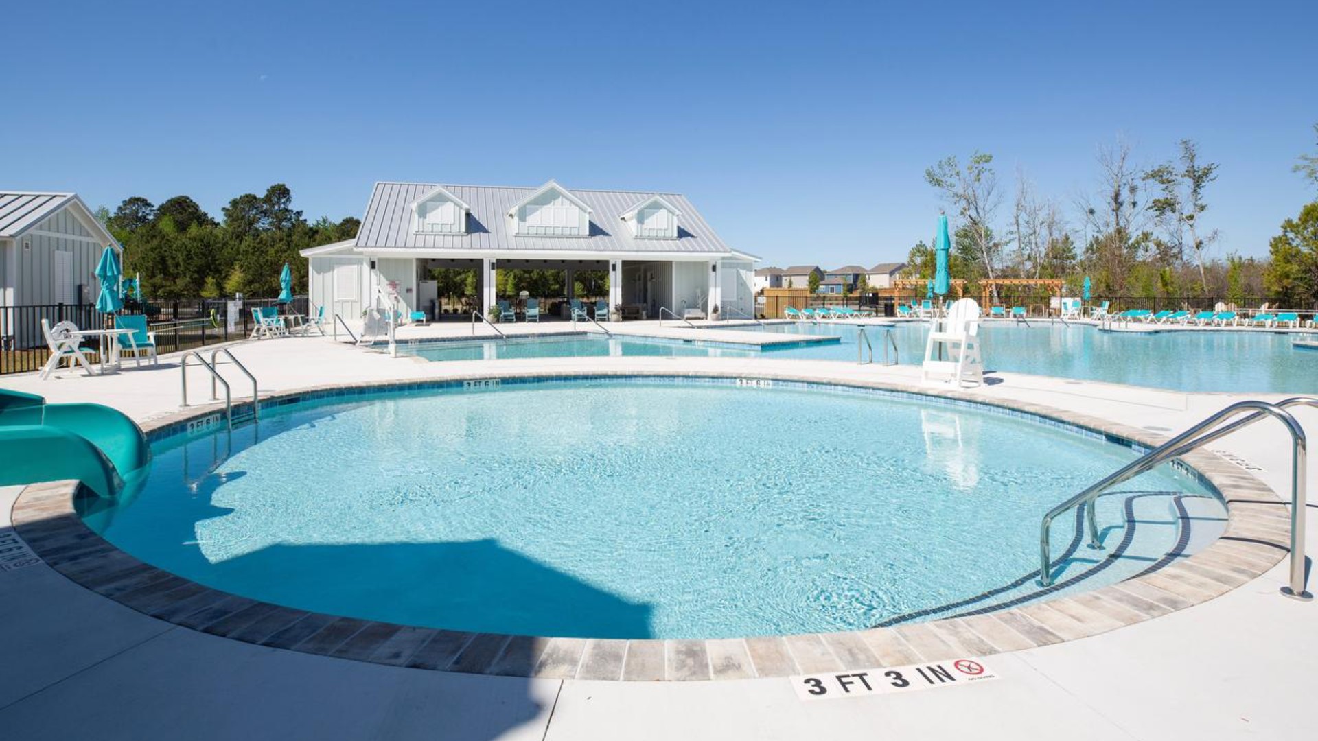 The amenity center that includes a swimming pool, multi-sport court, splashpad, playground, and fire pit, ensuring a well-rounded and enjoyable living experience.