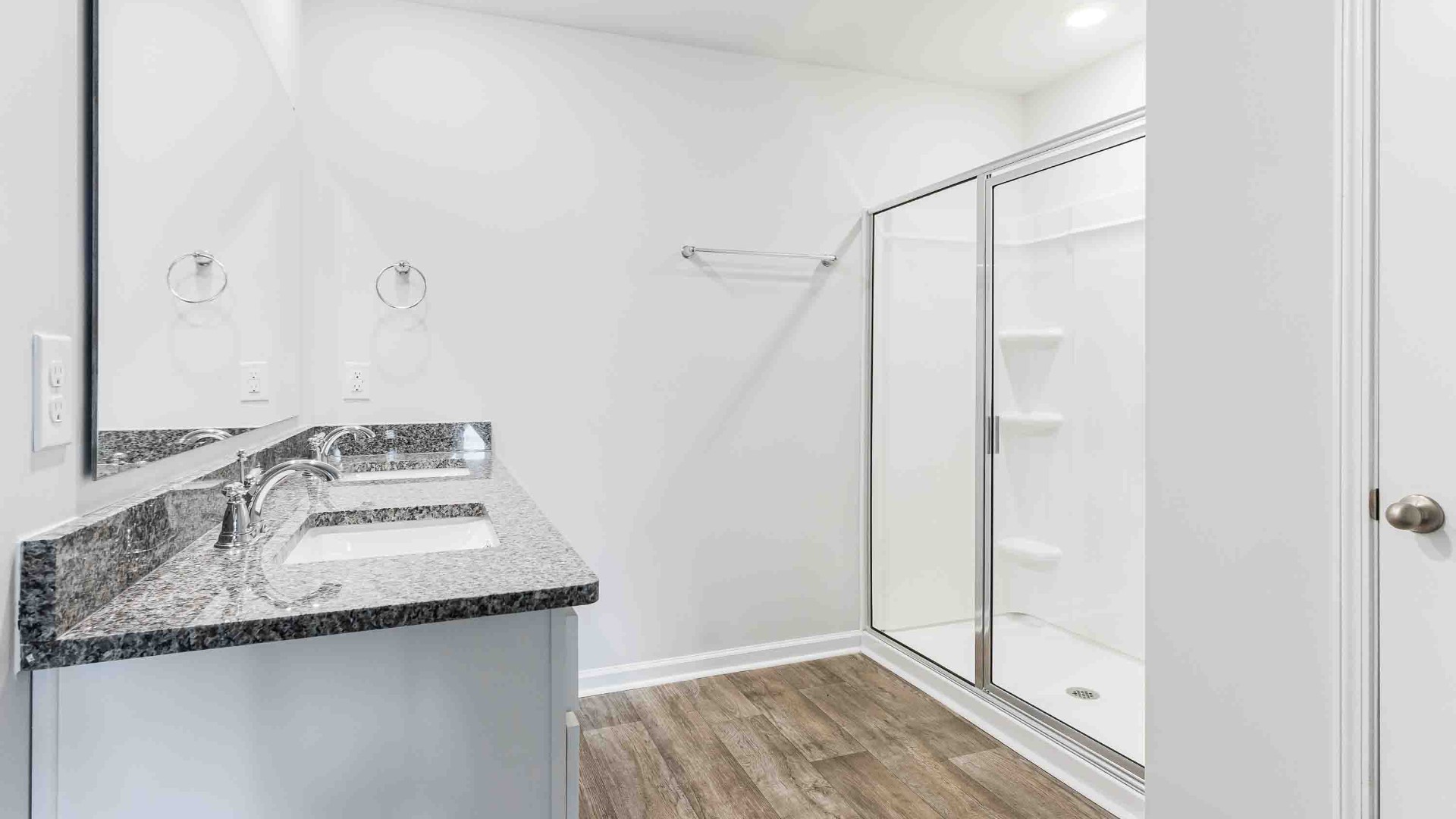 The Primary Suite offers a massive closet and a luxurious bathroom with a walk-in shower, linen closet, and dual vanity.