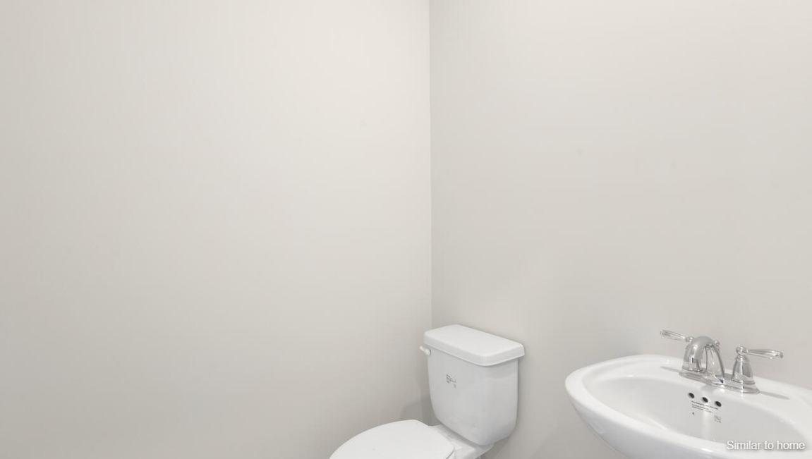 Its open-concept design includes a kitchen with granite countertops and stainless steel appliances, an island, and a walk-in pantry,