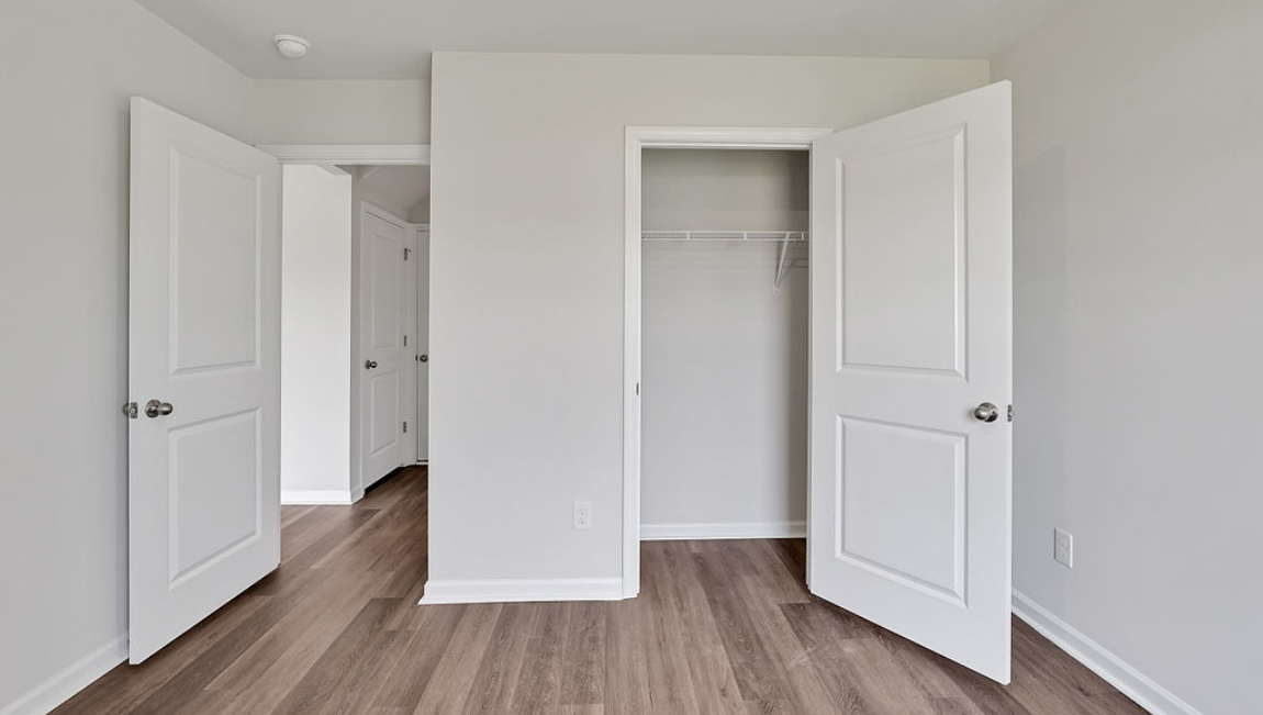 spacious primary suite upstairs features two walk-in closets, a spa-like bathroom with a double vanity, stand-up shower, and private water closet. Granite countertops are included in the bathroom and kitchen.