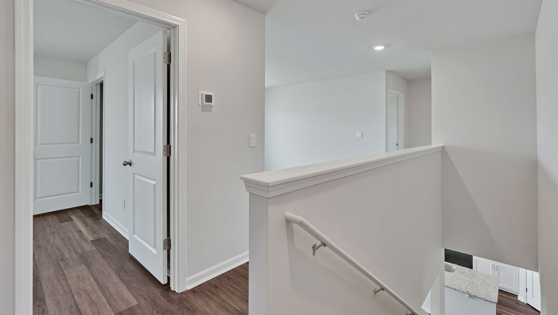spacious primary suite upstairs features two walk-in closets, a spa-like bathroom with a double vanity, stand-up shower, and private water closet. Granite countertops are included in the bathroom and kitchen.
