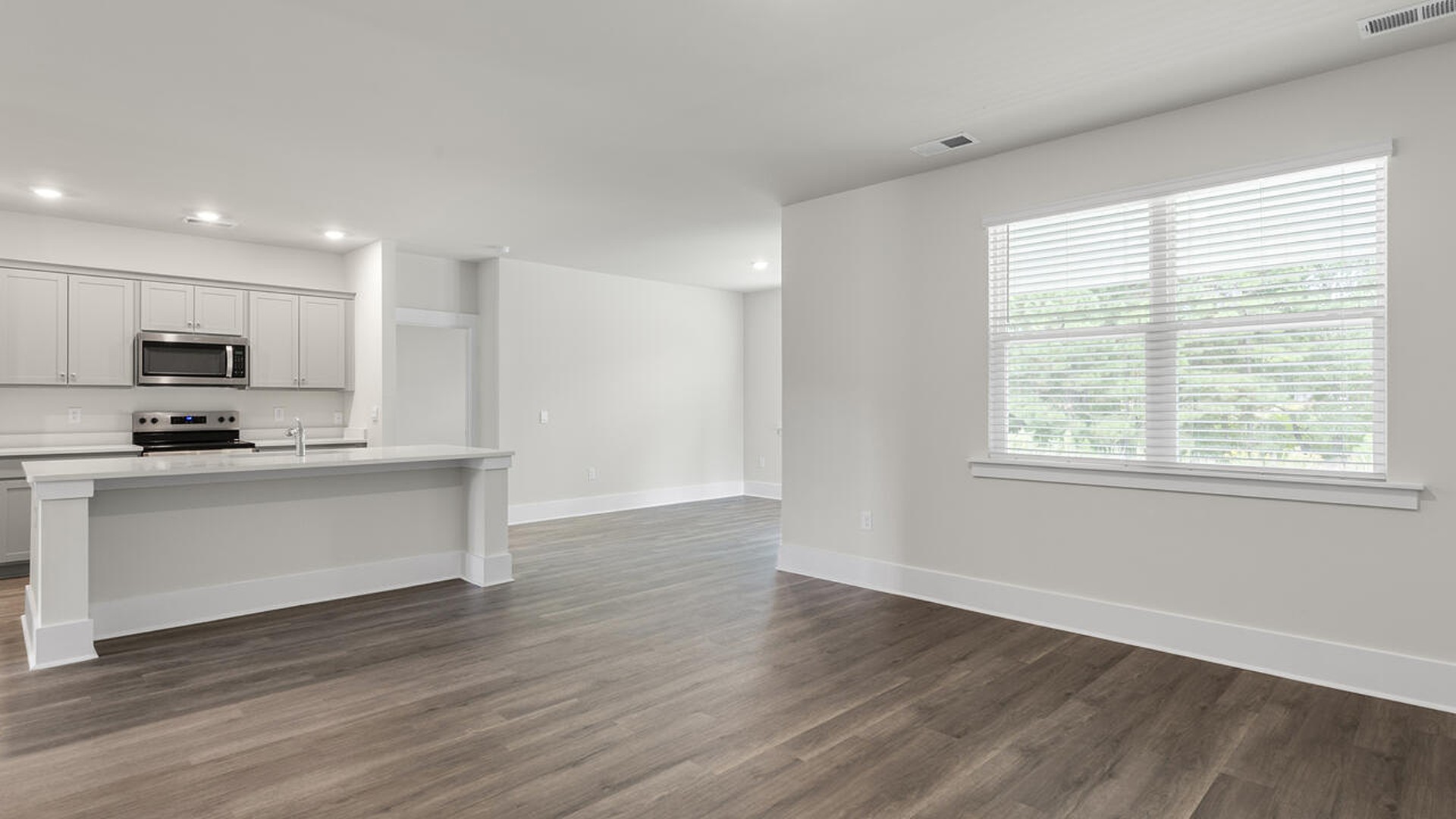 The Bradford is a versatile plan with an open concept kitchen, living, and dining area! The kitchen comes finished with beautiful granite countertops, stainless steel appliances, single-bowl sink and tile backsplash.