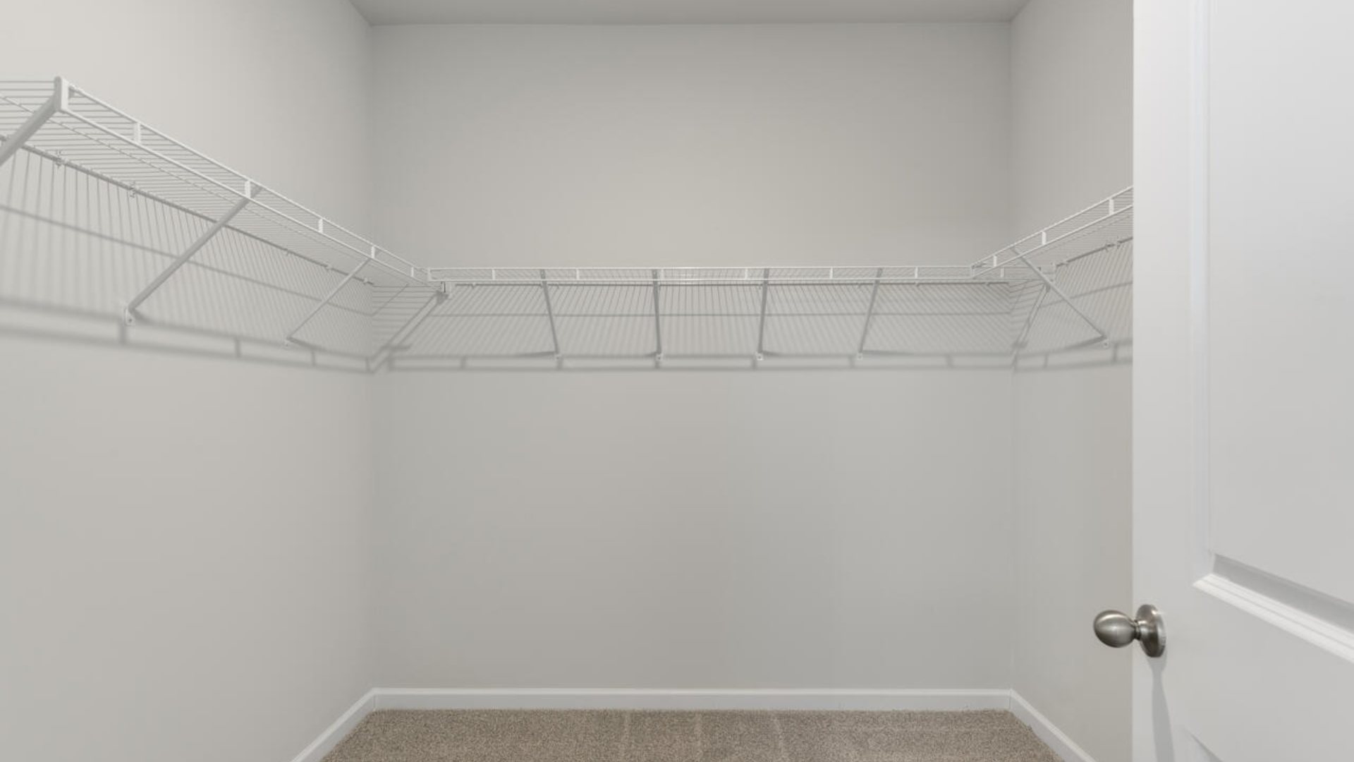 The Primary Suite offers a bathroom with a dual vanity, a walk-in shower, and a spacious closet.