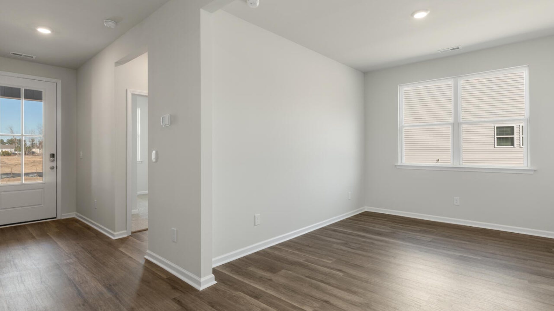 On the first floor, there are three additional bedrooms with low-maintenance LVP flooring and a flex room.