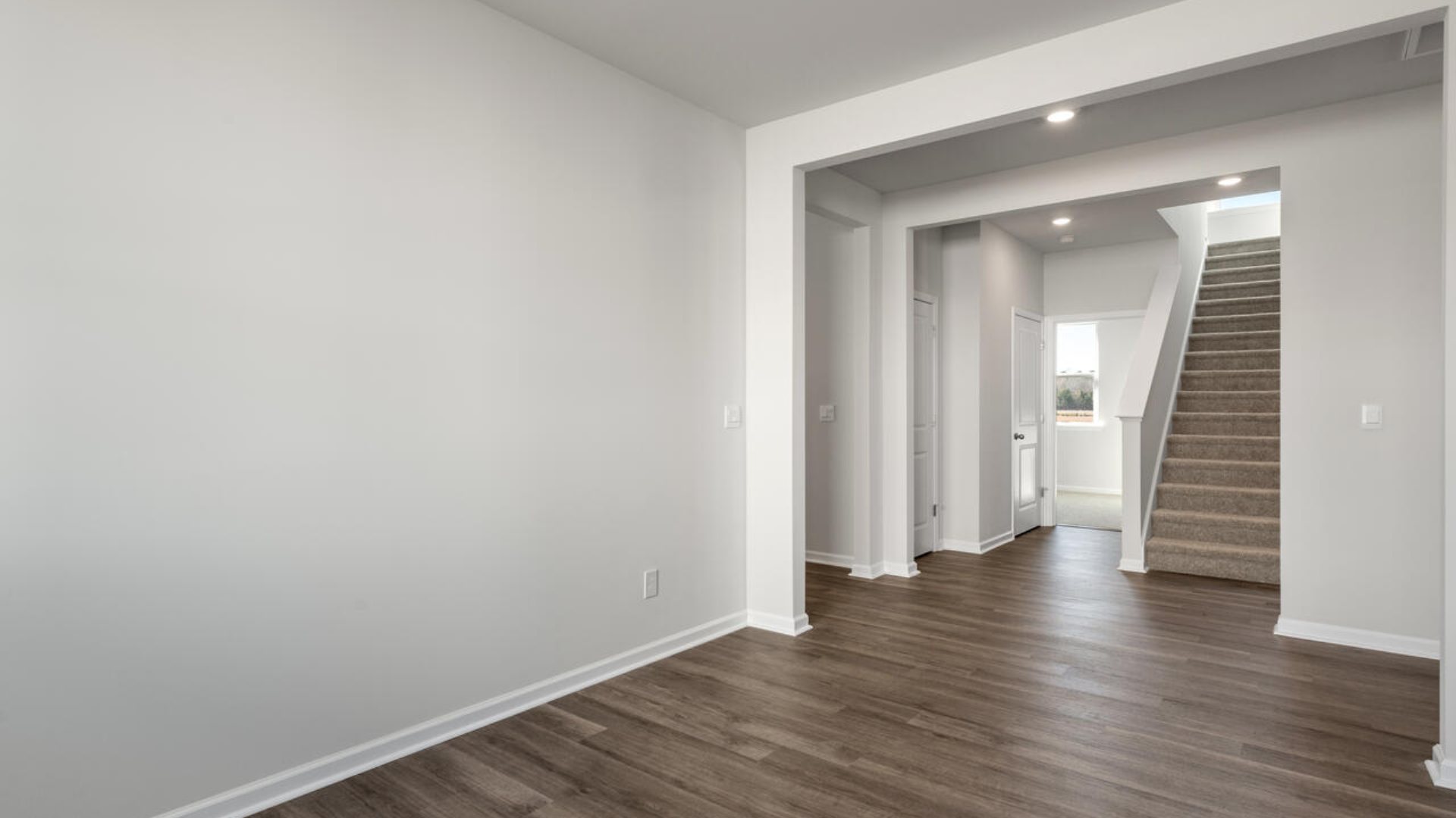 On the first floor, there are three additional bedrooms with low-maintenance LVP flooring and a flex room.