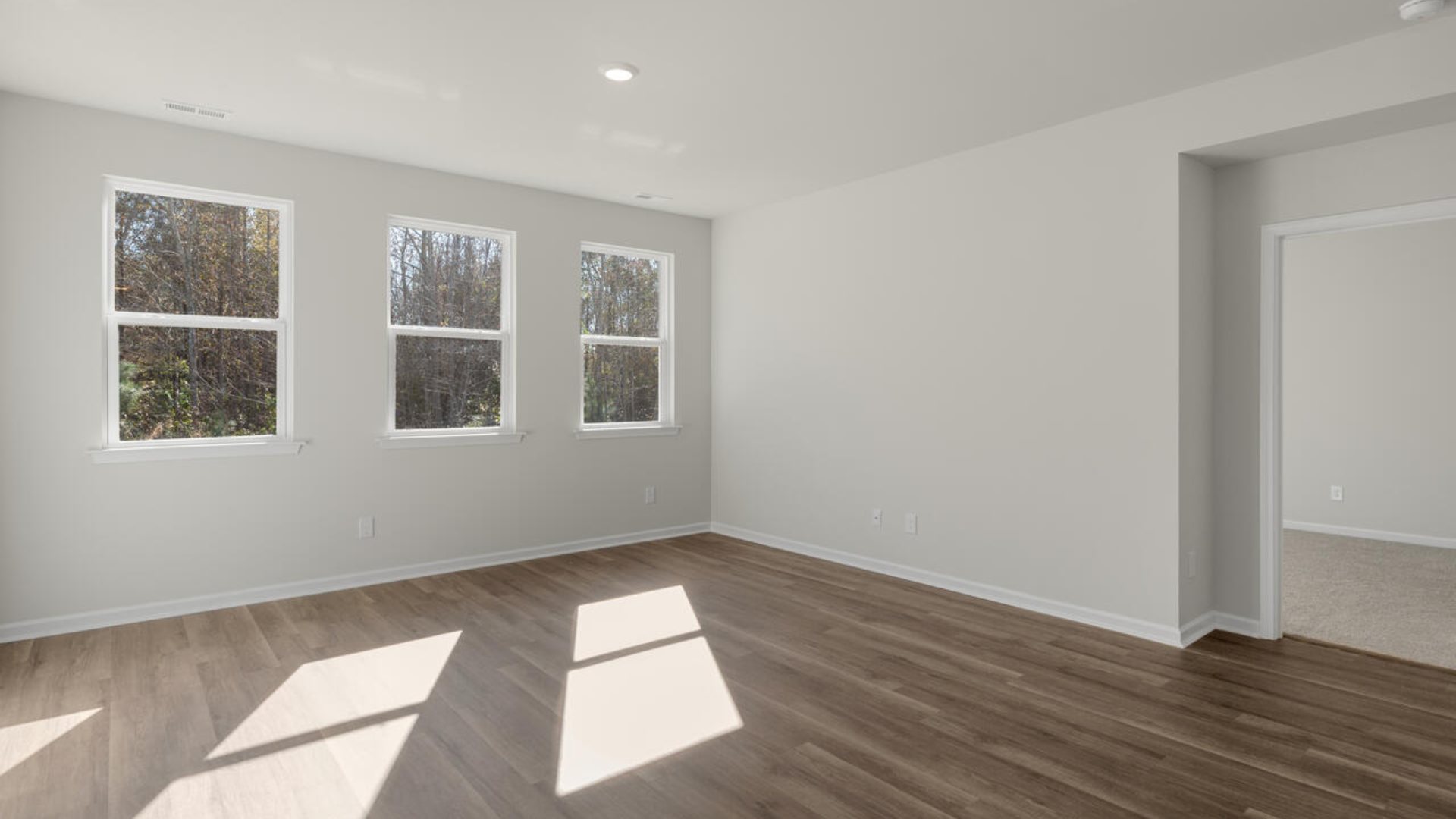 The Primary Suite offers a bathroom with a dual vanity, a walk-in shower, and a spacious closet.