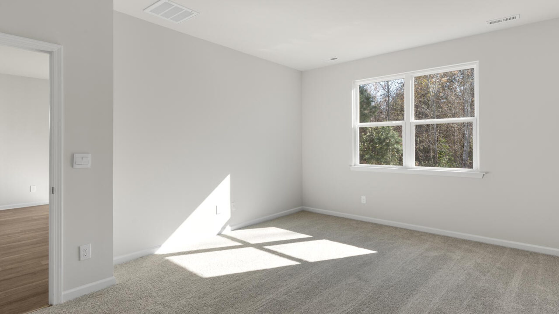 The Primary Suite offers a bathroom with a dual vanity, a walk-in shower, and a spacious closet.