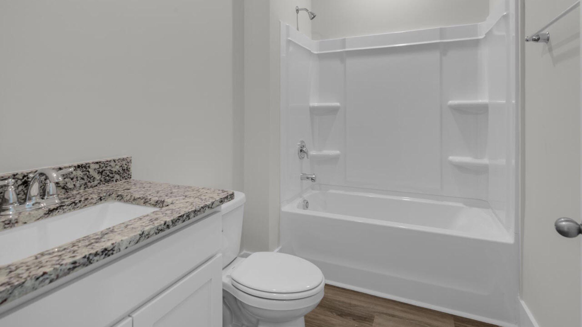 On the first floor, there are two additional bedrooms with low-maintenance LVP flooring and an office with French doors.