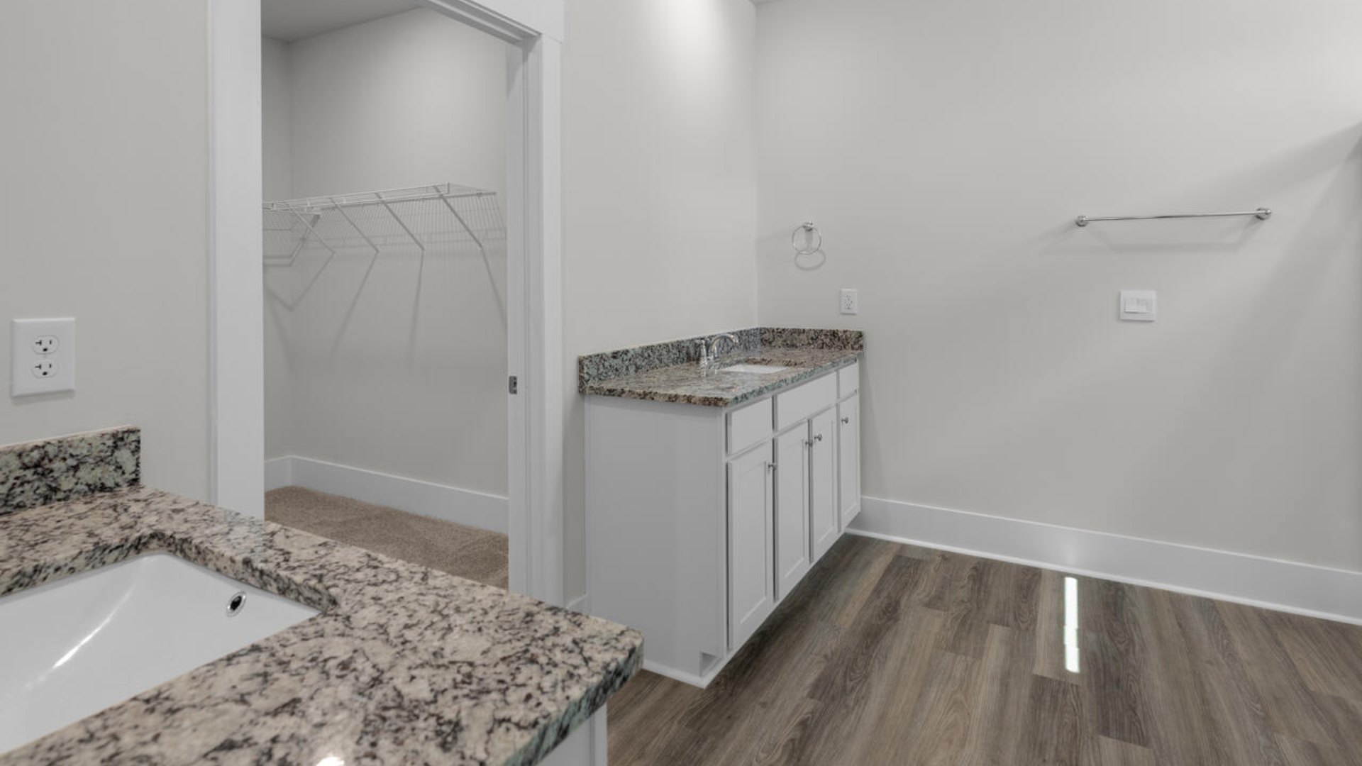 The Primary Suite offers a bathroom with a dual vanity, a walk-in shower, and a spacious closet.