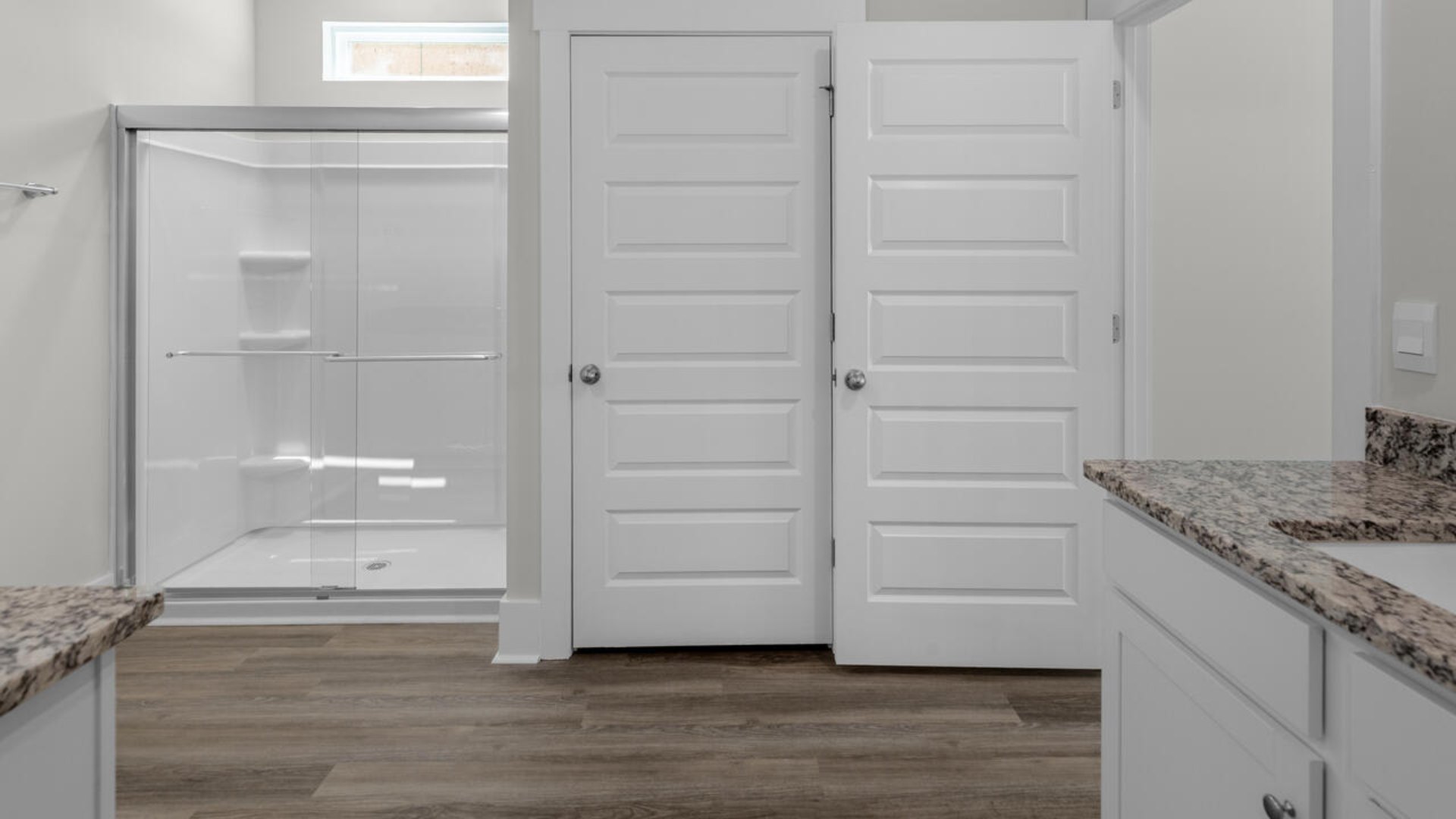 The primary suite as well as on suite is sure to impress with double vanities and a massive walk-in closet. A large, covered porch perfect for entertaining and enjoying the Carolina evenings
