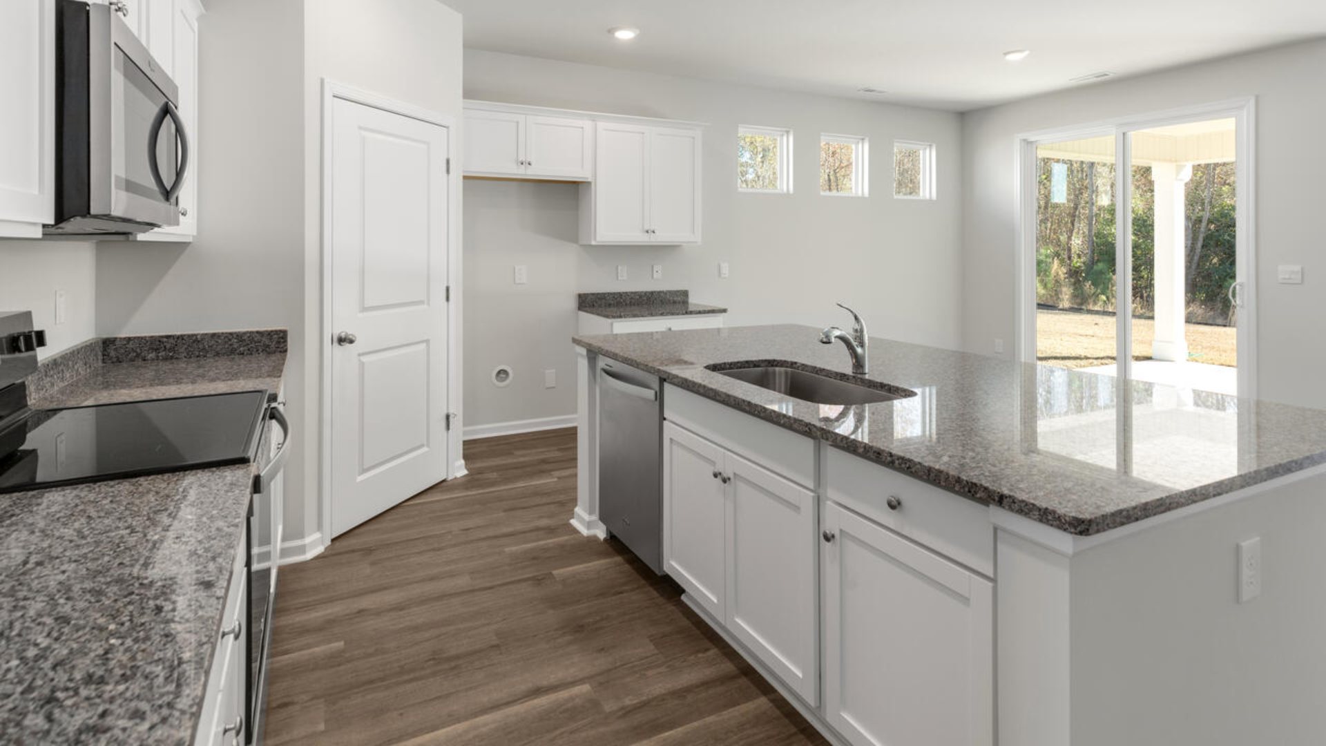This home boasts a large granite kitchen island that over looks the dining area and patio, as well as a 45-degree angle pantry for ample food storage. Granite Countertops and Stainless Steel Appliances. Large island.