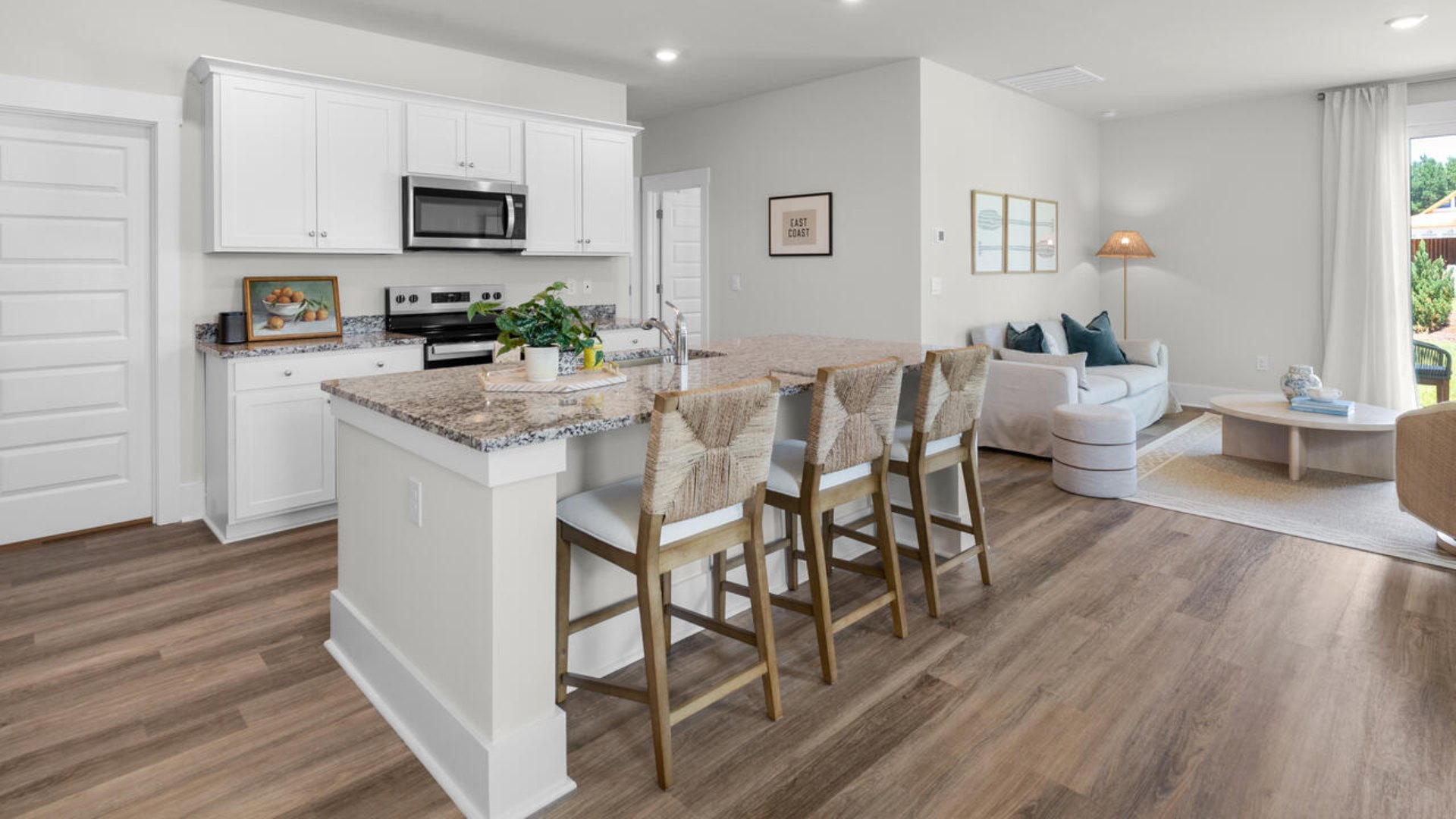 The gourmet kitchen stands out with its elegant granite or quartz countertops and Whirlpool stainless steel appliance package.