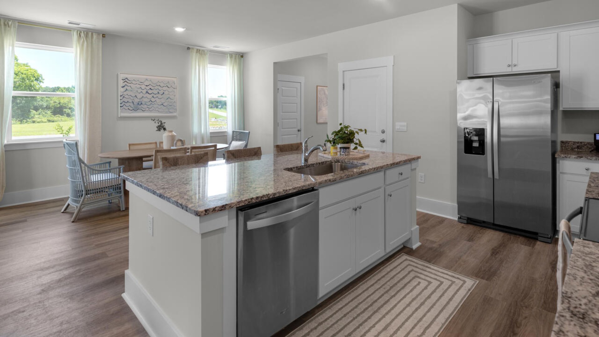 The gourmet kitchen stands out with its elegant granite or quartz countertops and Whirlpool stainless steel appliance package.