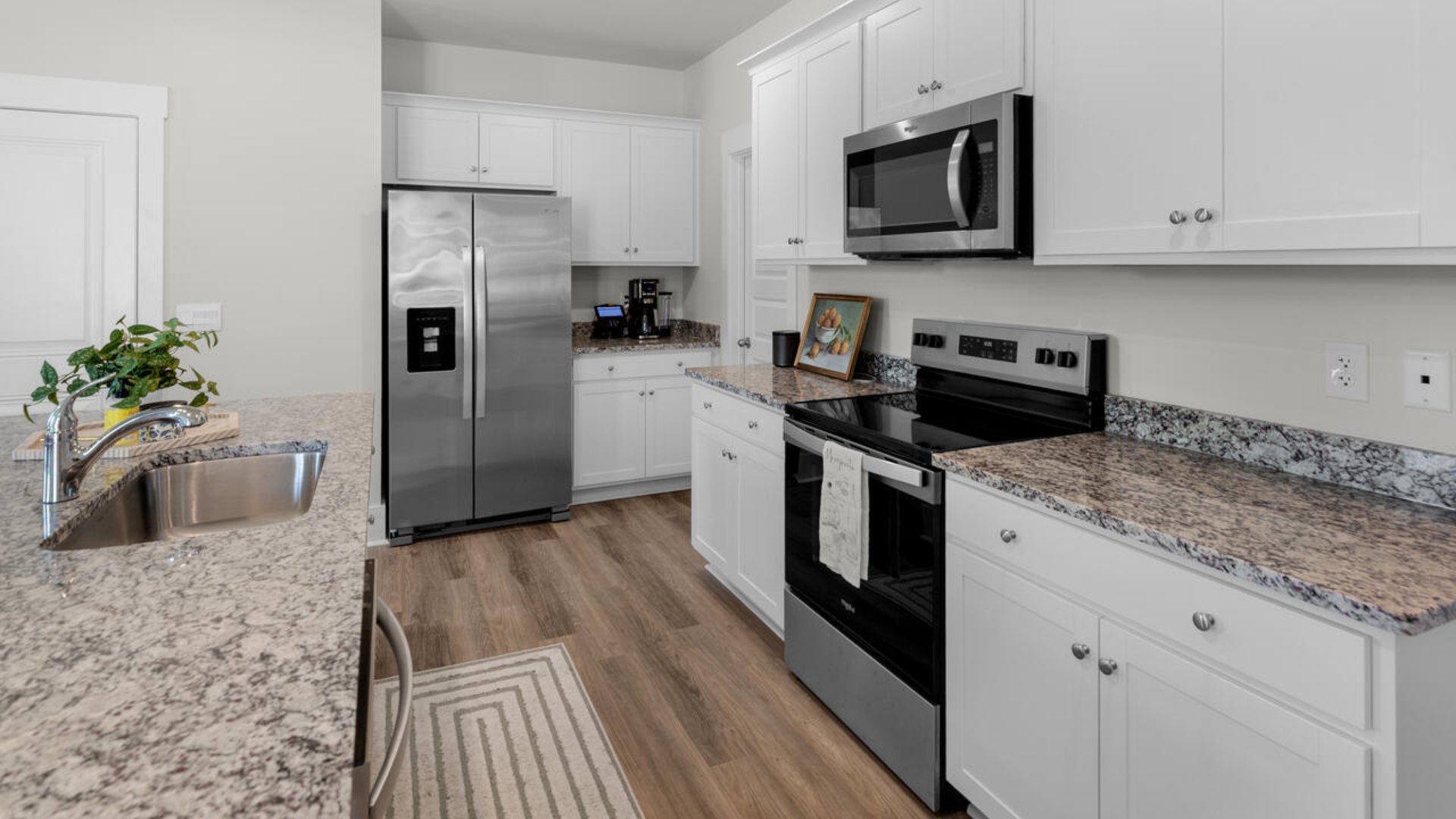 he gourmet kitchen stands out with its elegant granite or granite countertops. tile backsplash and stainless-steel appliance package.